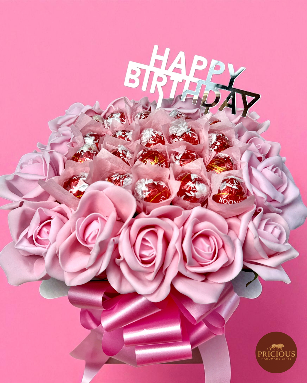 Close-up of Lindt truffle and pink rose birthday gift bouquet