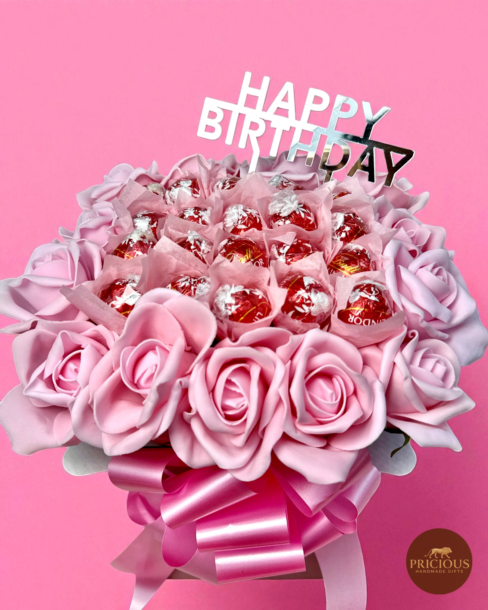 Close-up of Lindt truffle and pink rose birthday gift bouquet