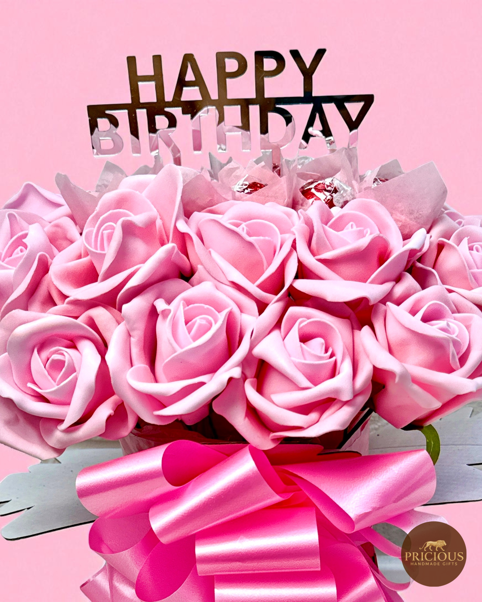 Close-up of Lindor truffles nestled in pink roses
