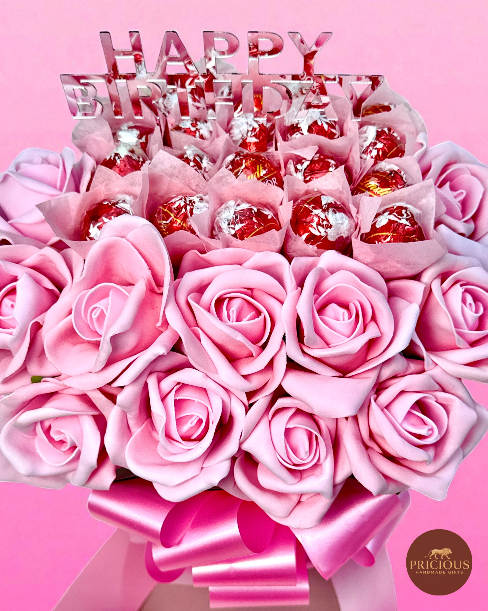 Side view pink hatbox chocolate bouquet with mirror topper