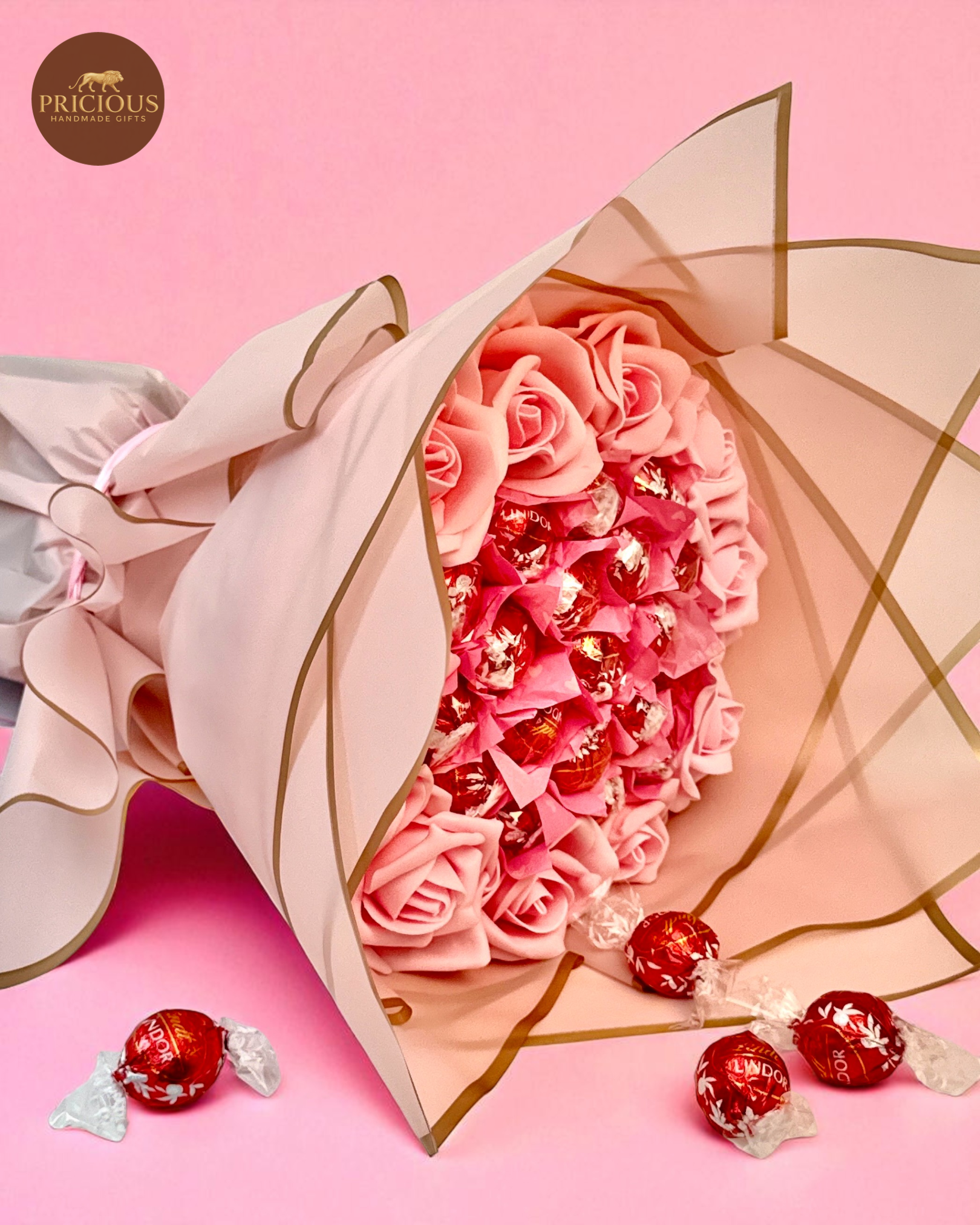 Side view pink rose & Lindor truffle bouquet in blush wrap