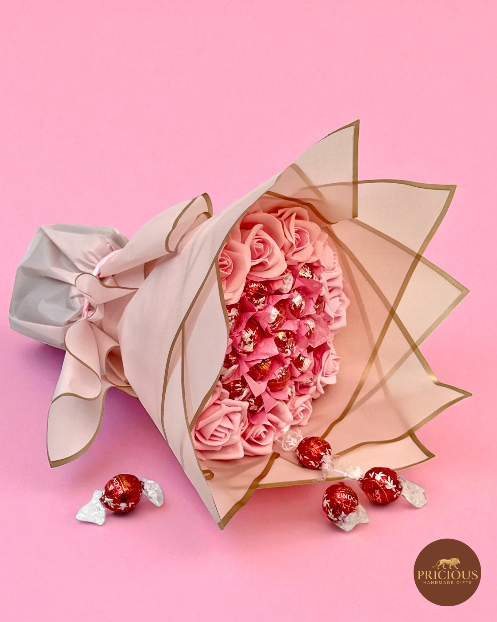 Blush pink Lindt Lindor chocolate gift bouquet with roses and gold-edged wrap