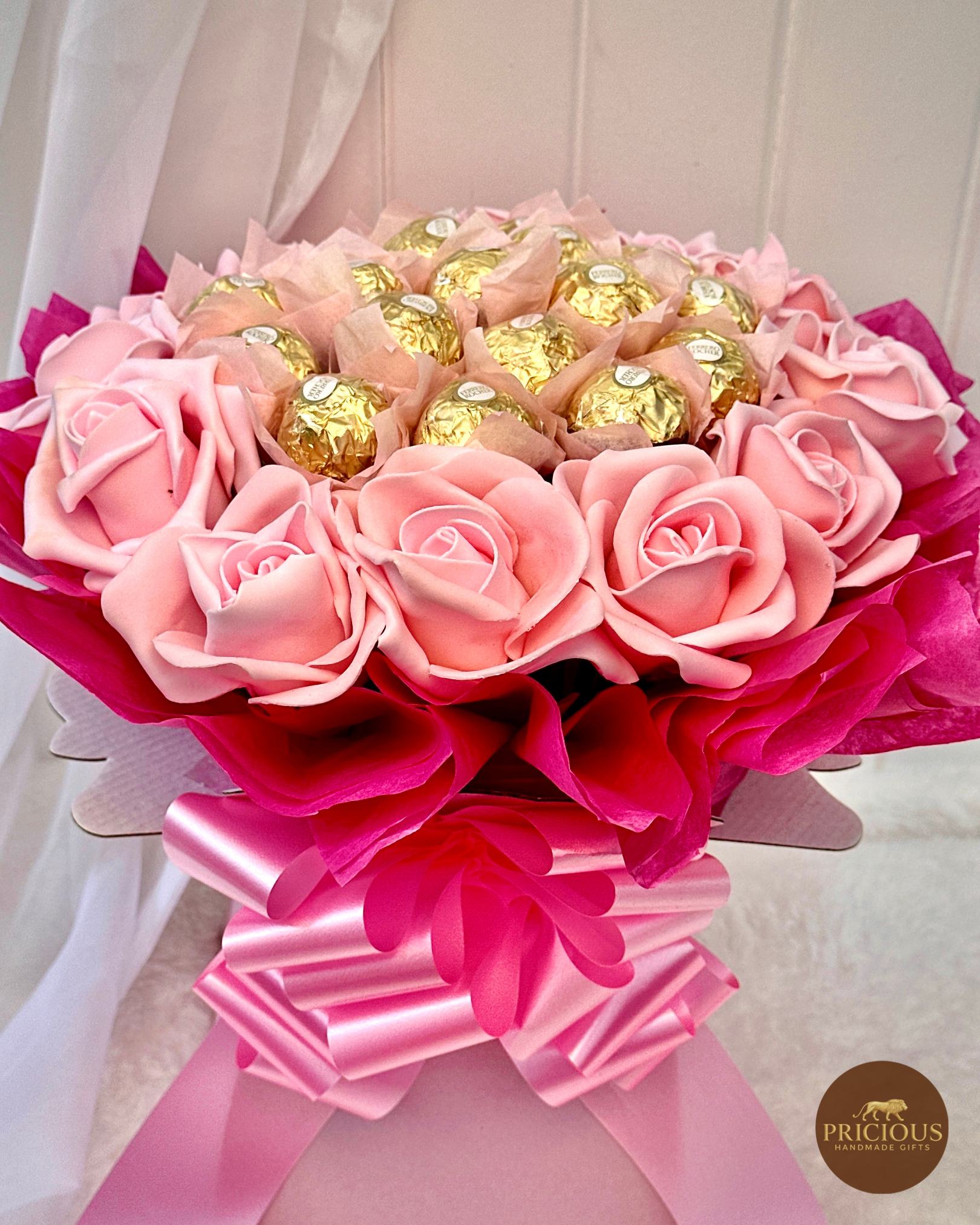 Close view hot-pink wrap Ferrero Rocher rose bouquet