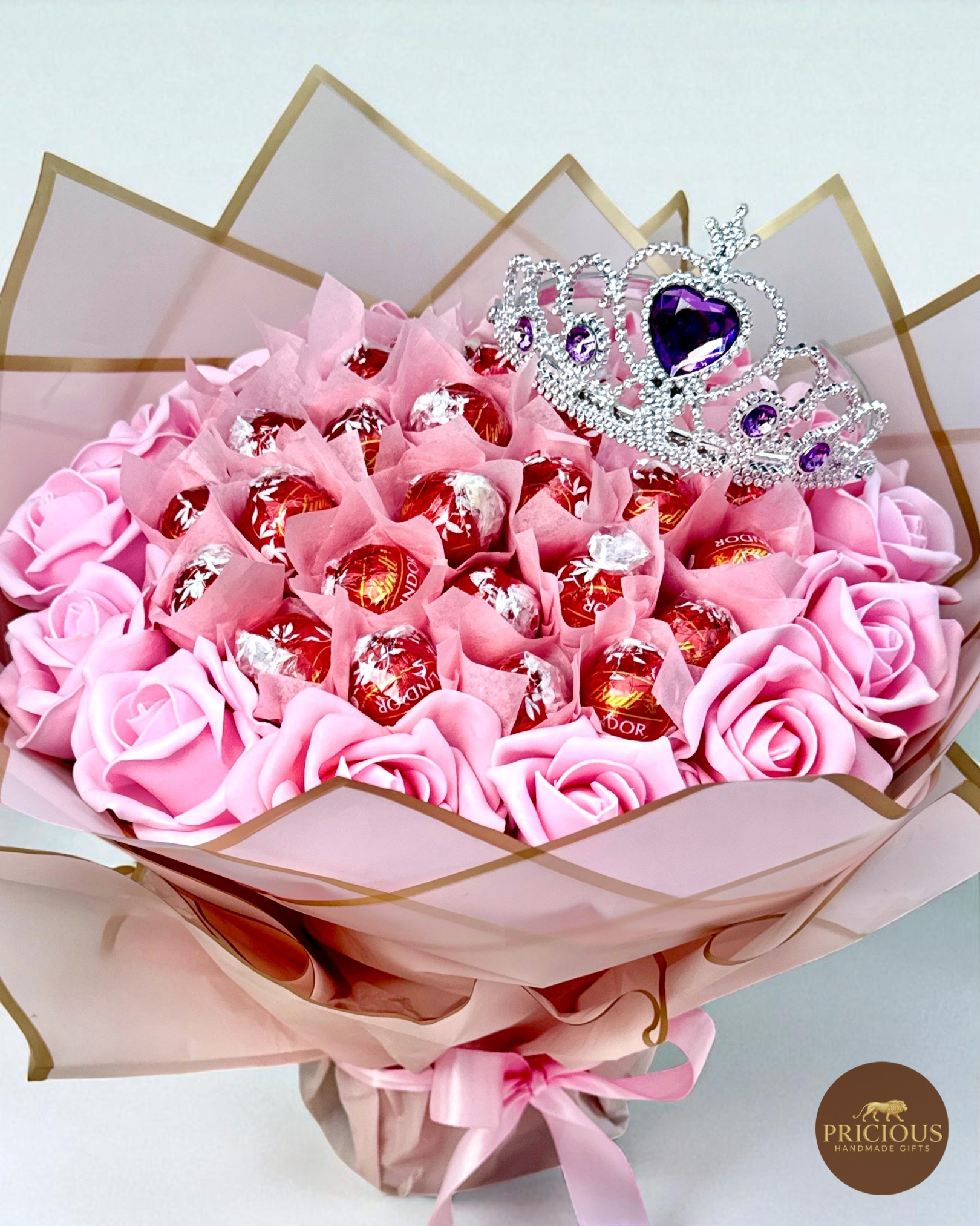 Close view Lindt Lindor truffle bouquet, pink roses & gold-edge wrap