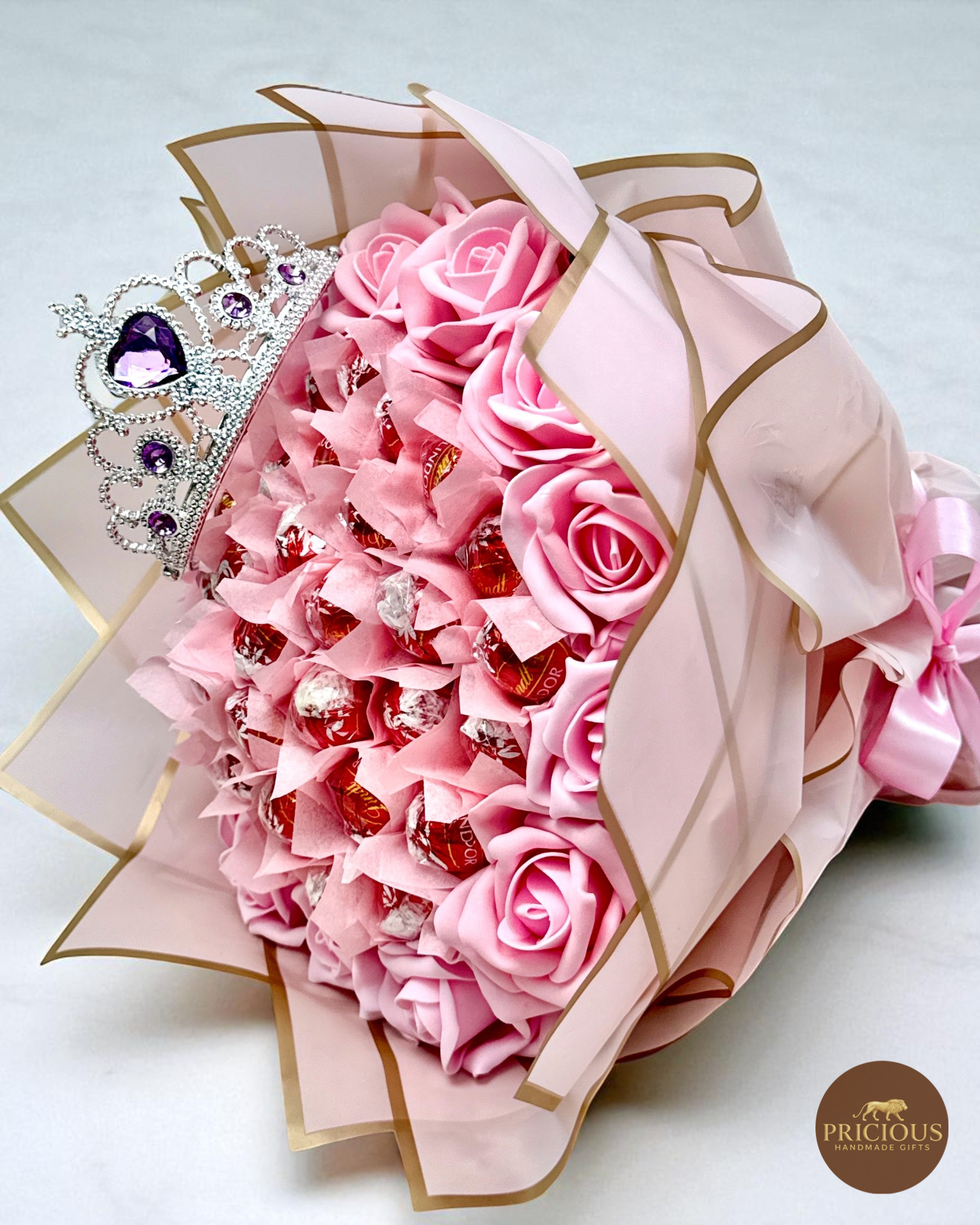 Close view Lindt tiara rose chocolate gift bouquet in pink wrap