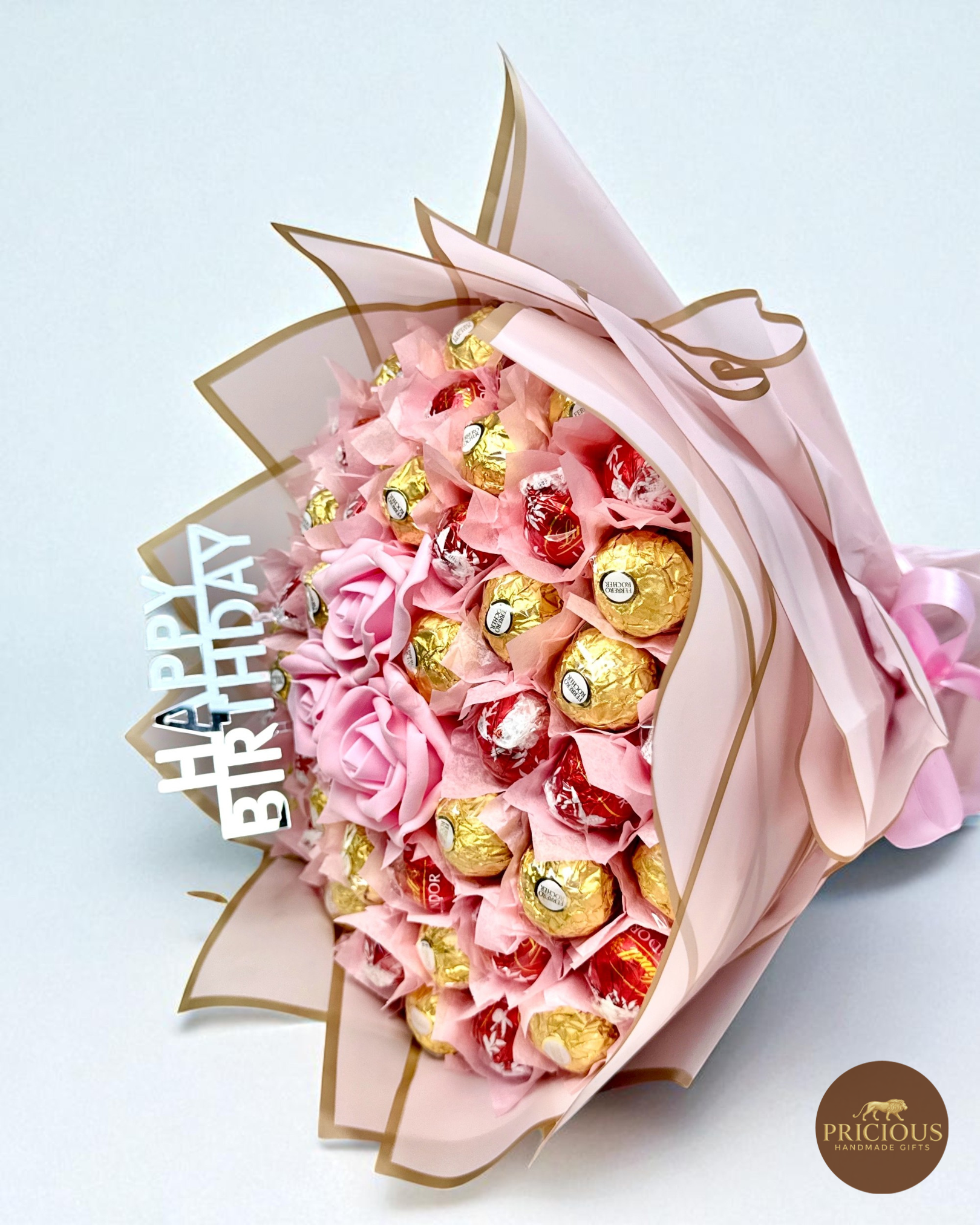 Side view of Lindor & Ferrero bouquet with blush roses