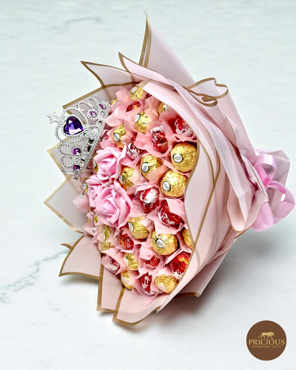 Side view tiara chocolate bouquet with blush pink roses and gold-edged wrap