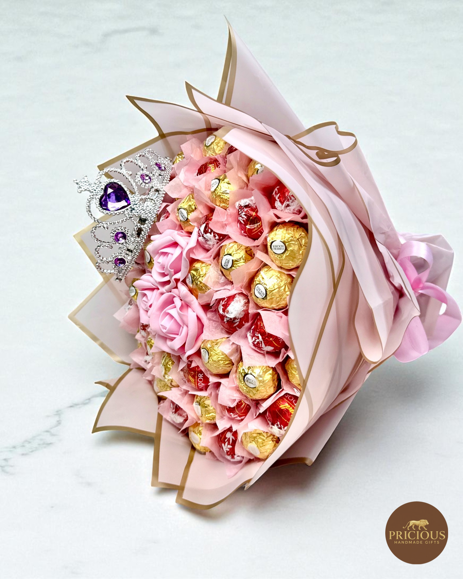 Side view tiara chocolate bouquet with blush pink roses and gold-edged wrap