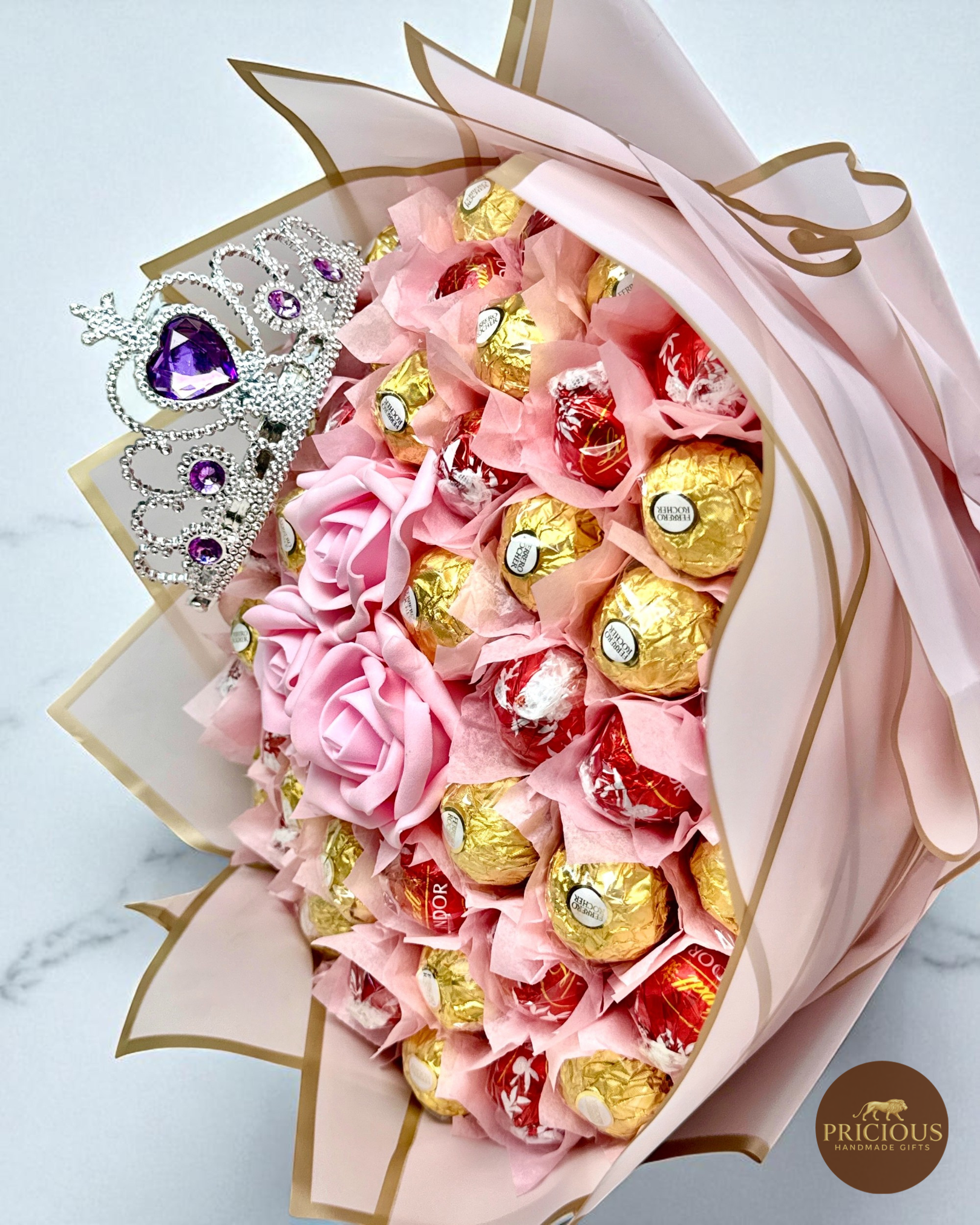 Close-up of tiara crown over Ferrero Rocher & Lindor truffles