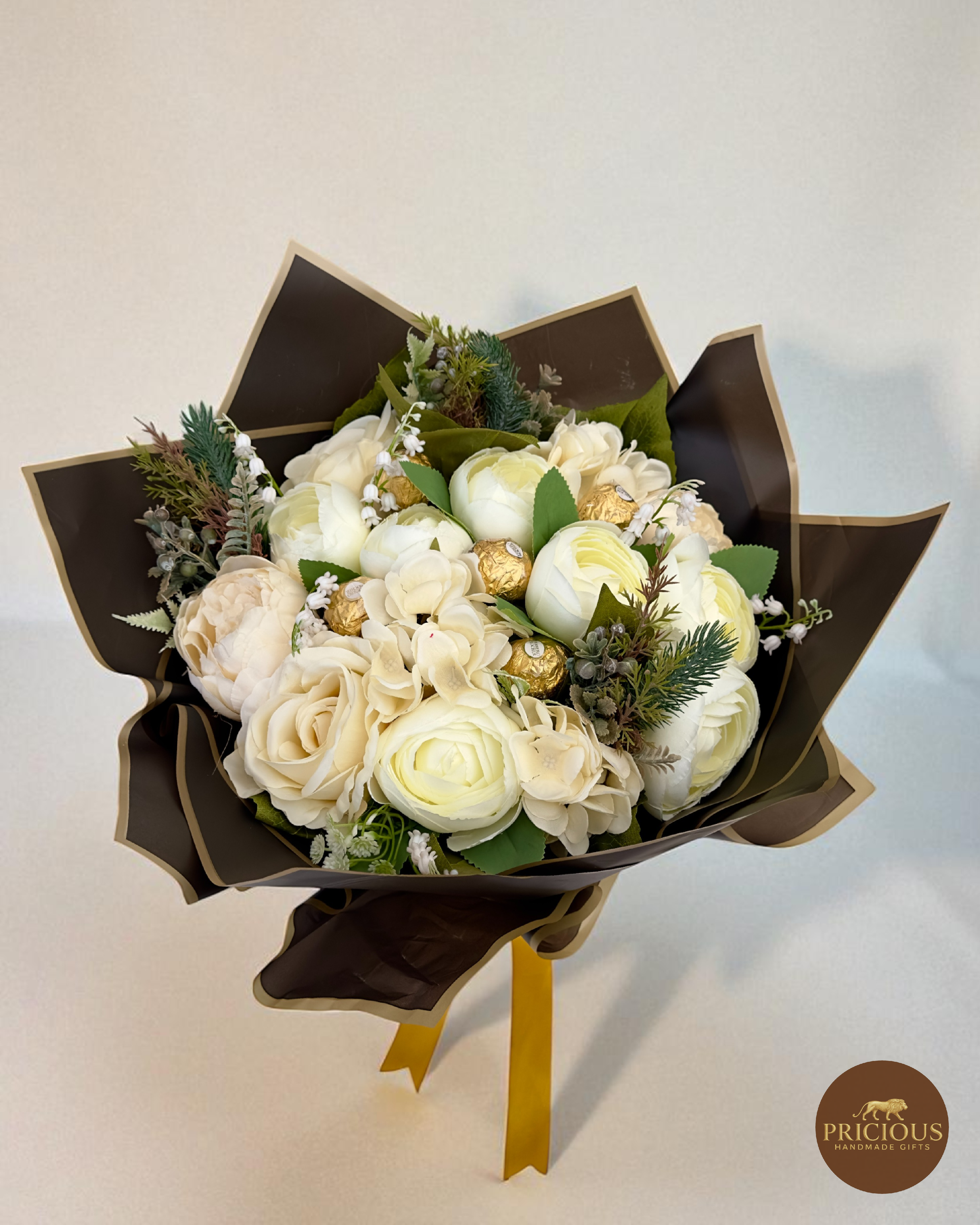 Side-top view mocha-wrapped ivory chocolate bouquet with gold satin bow