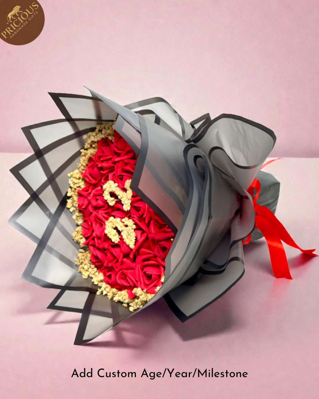 Red rose ‘22’ number bouquet with gold accents, layered grey wrap and red ribbon.