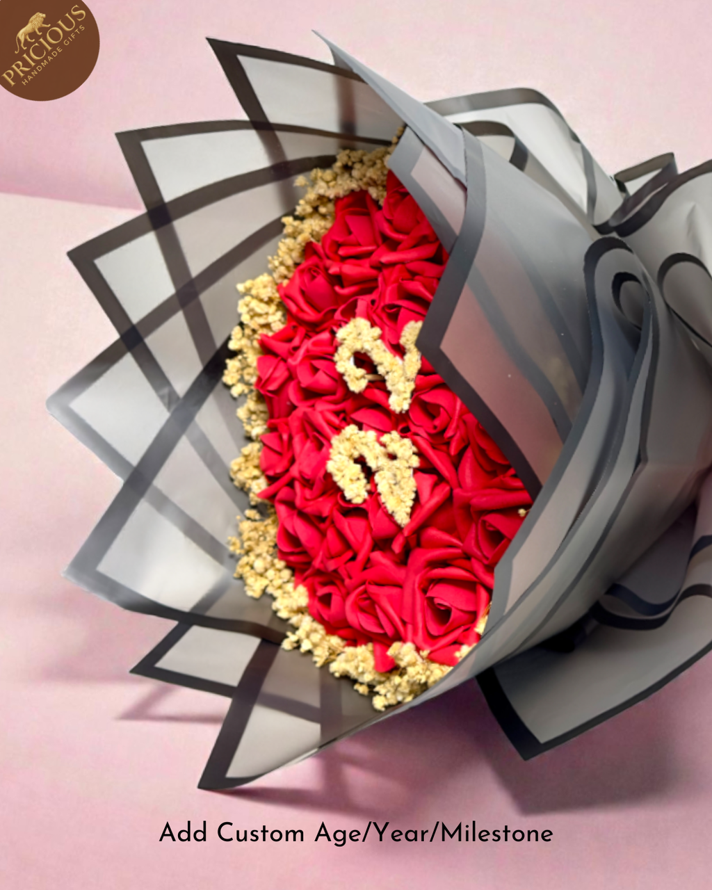 Red rose ‘22’ number bouquet with gold accents, layered grey wrap and red ribbon.
