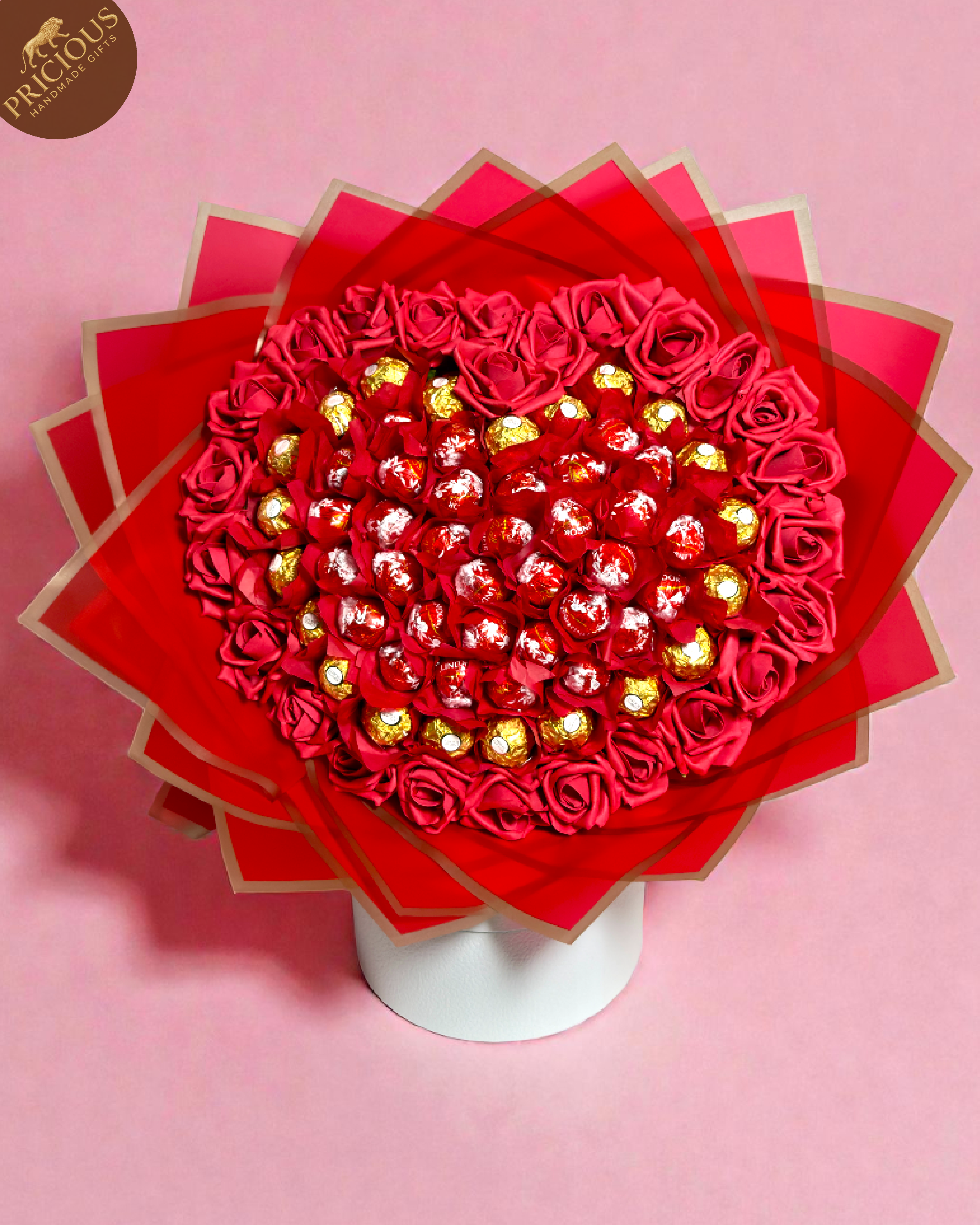 Heart-shaped Ferrero Rocher and Lindt Lindor chocolate bouquet with red roses and premium wrap.