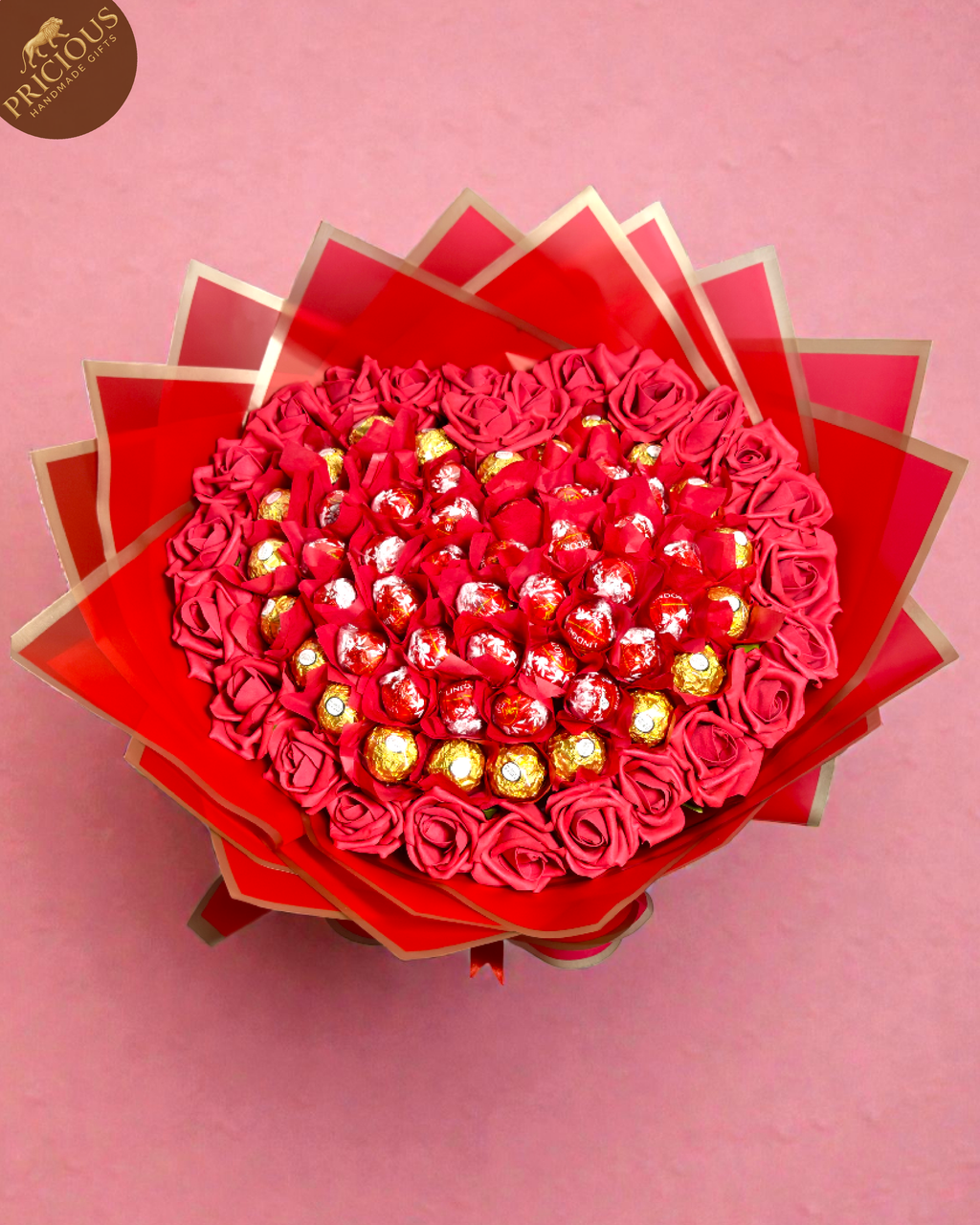 Top view of luxury heart chocolate bouquet with mixed gold and red truffles.