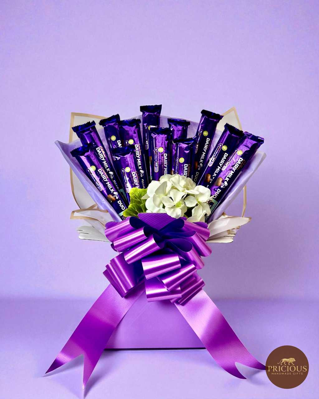 Cadbury Dairy Milk chocolate bouquet in royal purple with ivory flowers and satin bow