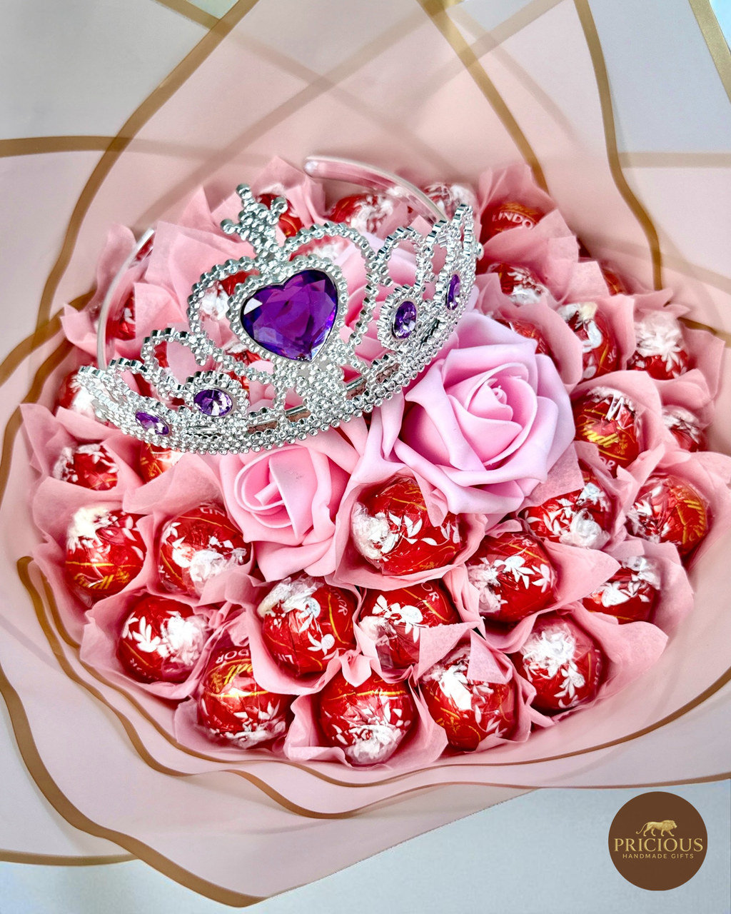 Close-up of Lindor truffles with blush roses and tiara