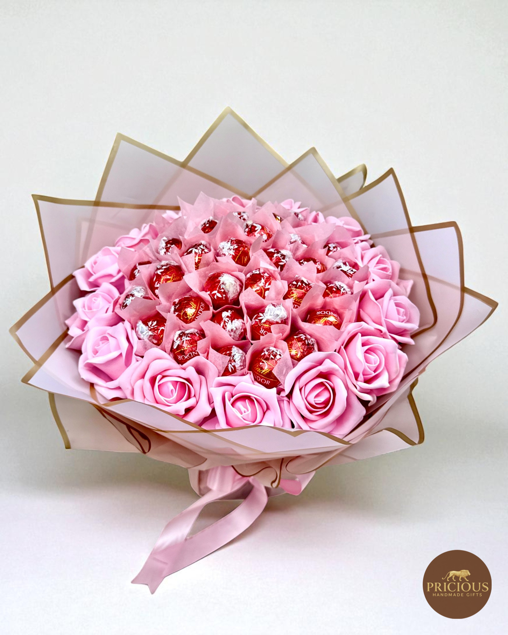 Front view Lindt Lindor bouquet with blush roses and gold-edged wrap