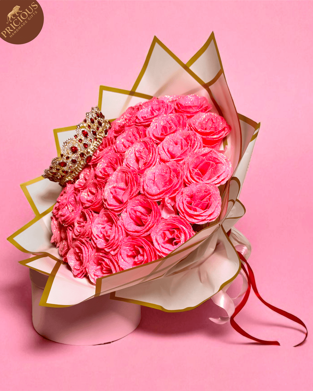Hand-tied pink glitter rose bouquet with tiara topper, artificial roses, layered wrap.