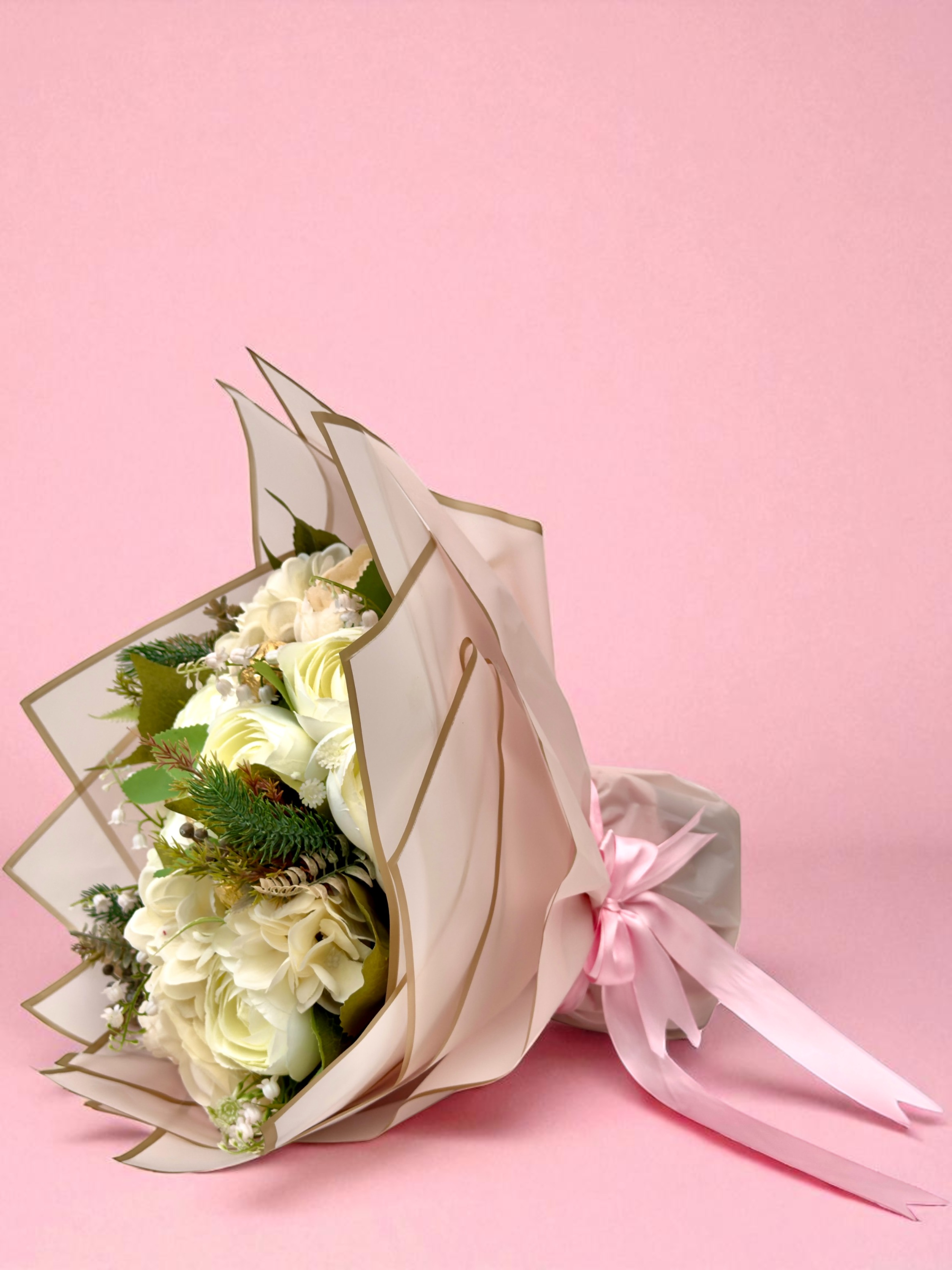 Bouquet of Maltesers chocolate bars arranged in a decorative box on a beige background