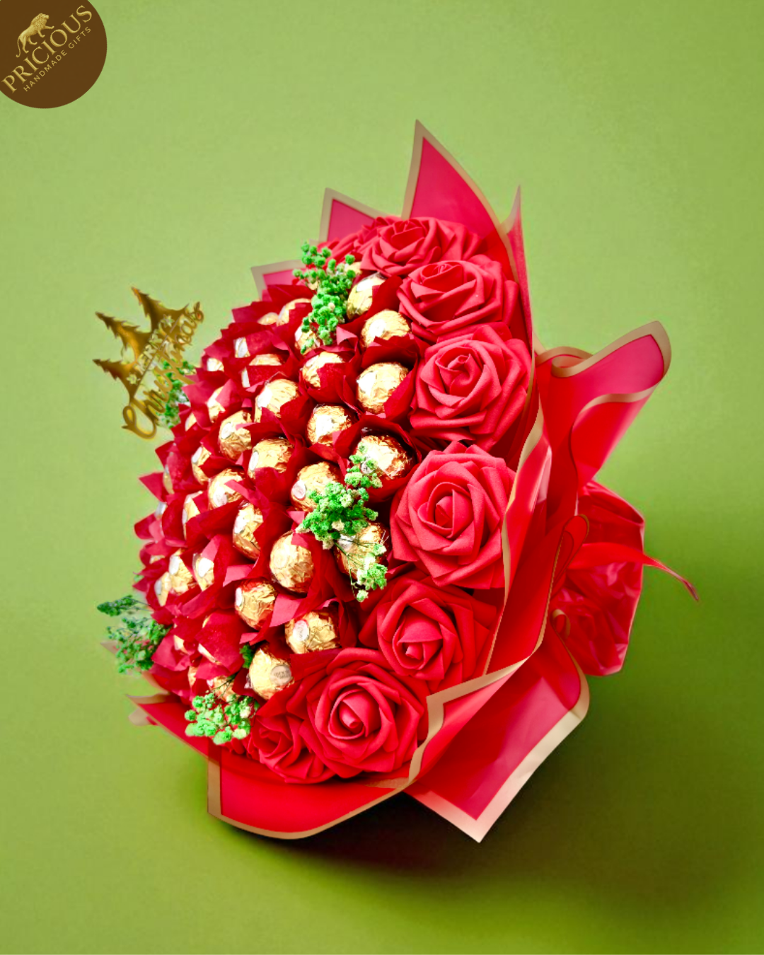 Hand-tied Ferrero Rocher red Christmas chocolate bouquet with artificial foam roses and gold-edged wrap.
