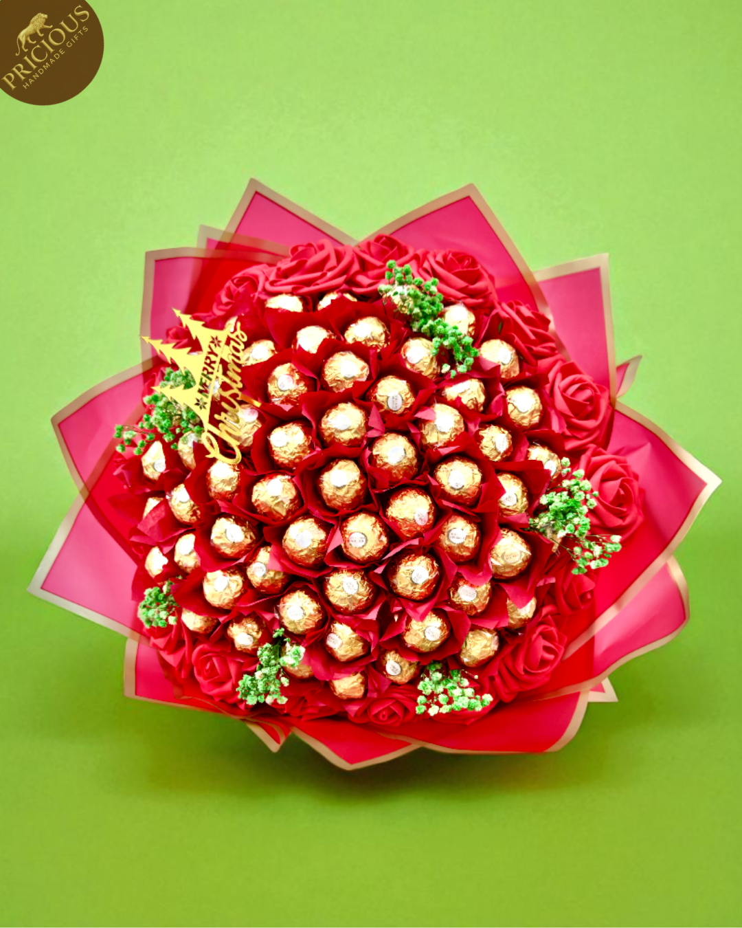 Top-down view showing chocolates arranged with festive greenery; handmade in the UK.