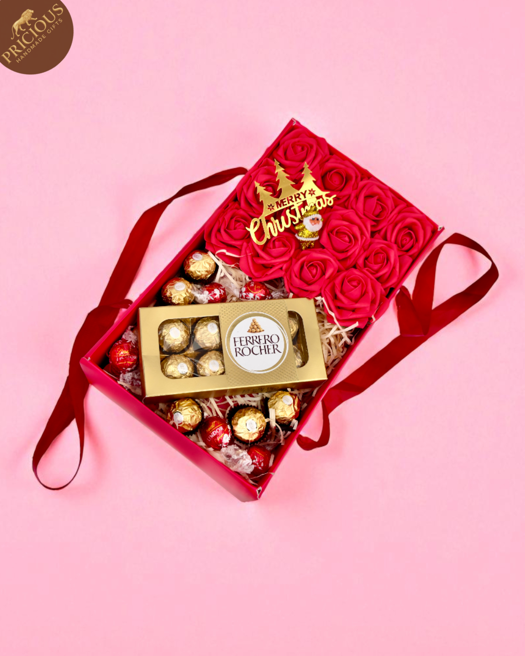 Ferrero Rocher chocolates in a decorative box with red roses on a pink background