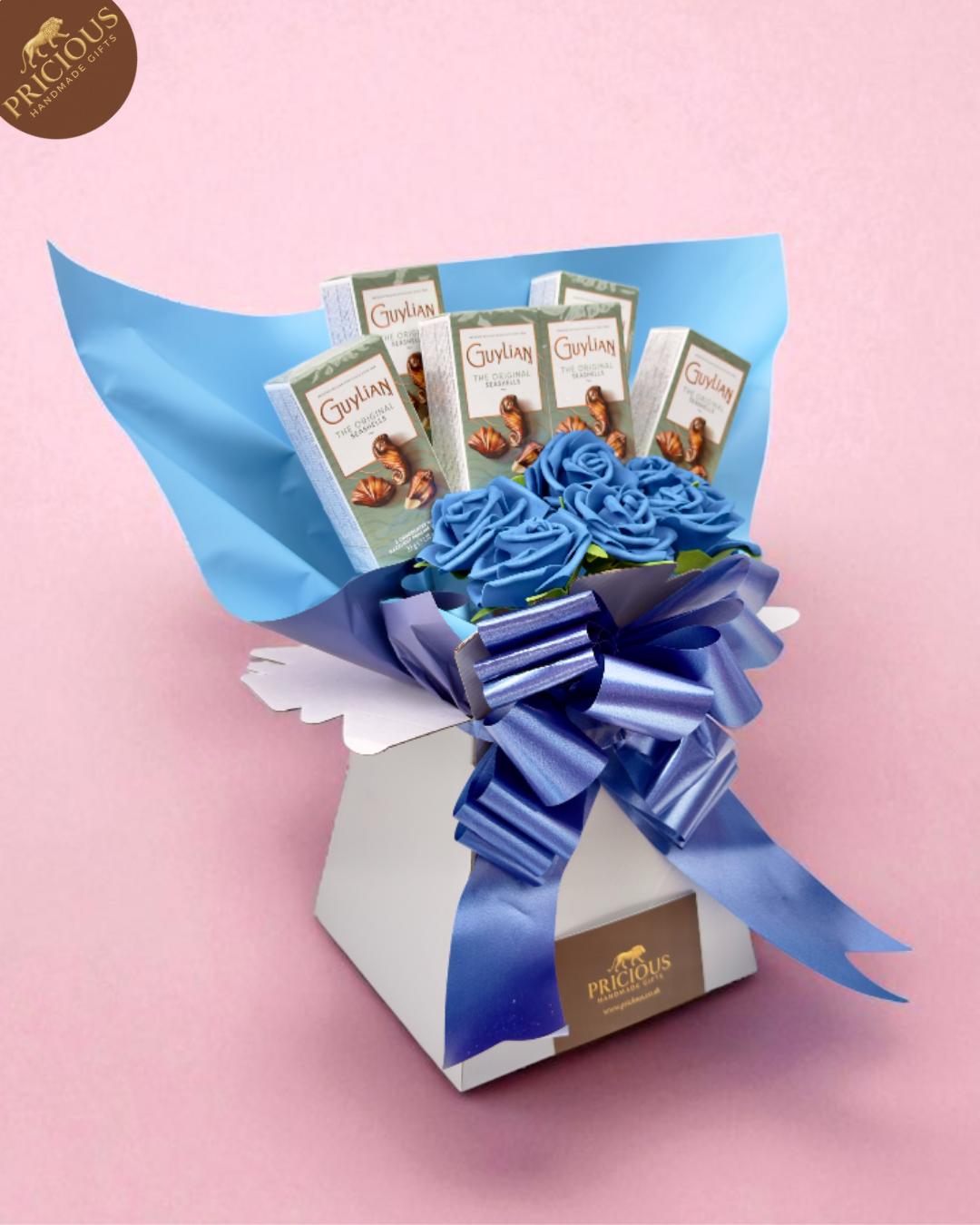 Side view of blue rose bouquet box showcasing six Guylian bars and layered wrap.