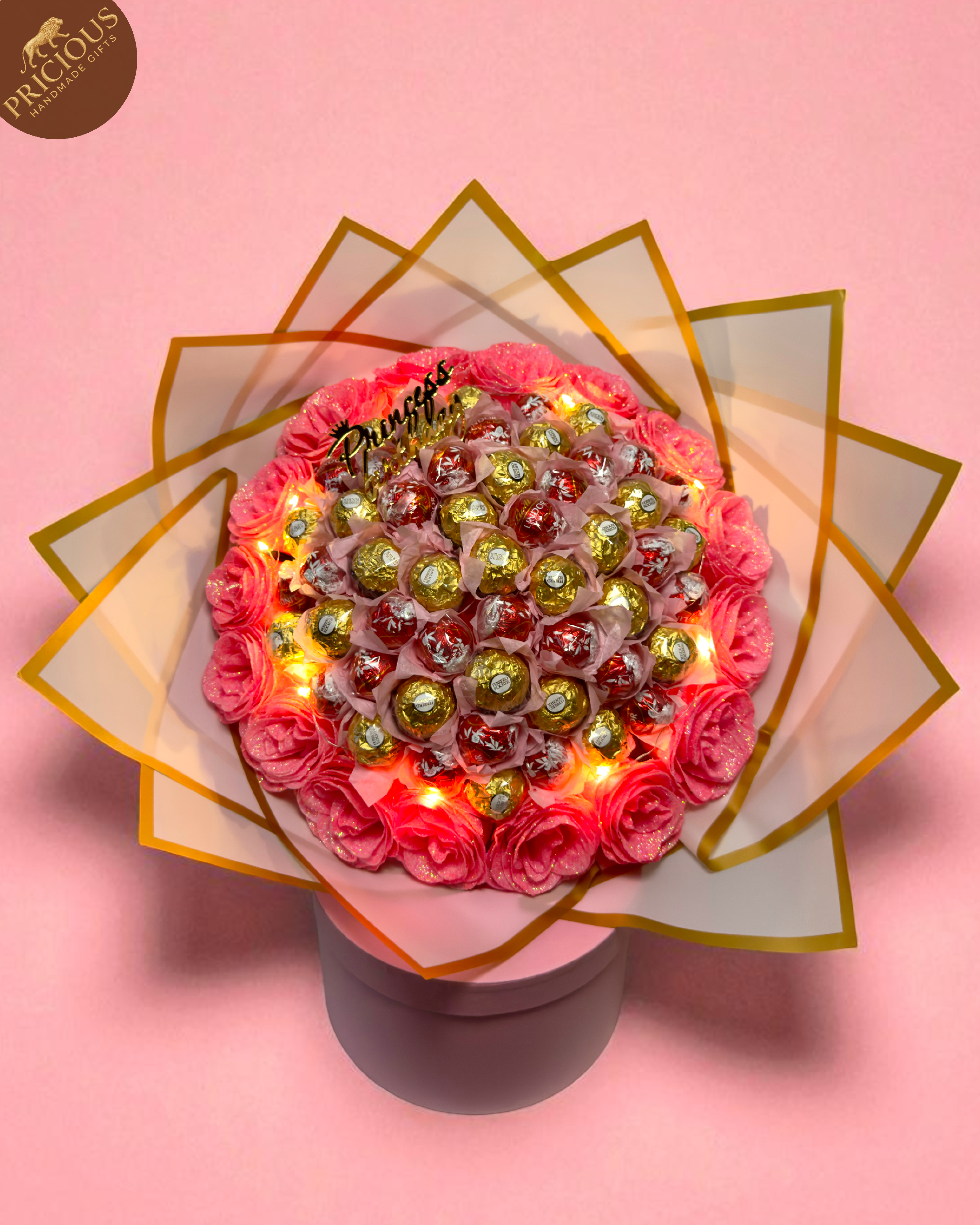Top-down view of the mixed Ferrero & Lindor bouquet, arranged around pink glitter roses, handmade in the UK.