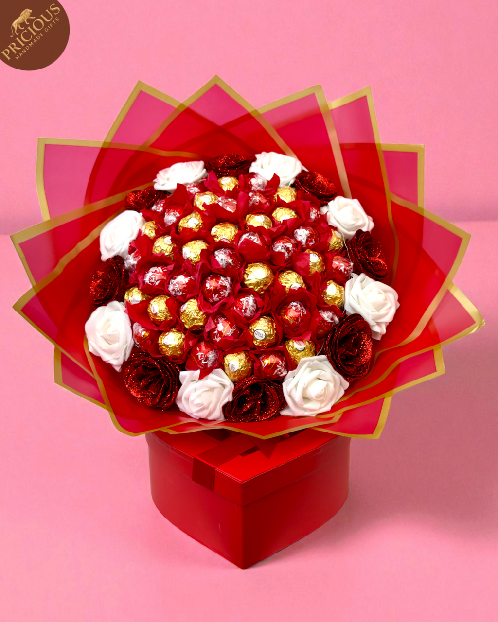 Top view of hand-tied Ferrero & Lindt bouquet with artificial roses and LED lights