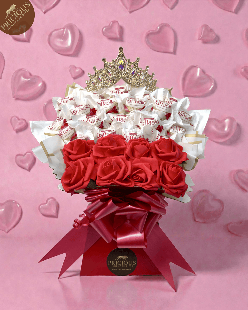 Hand-tied Ferrero Raffaello bouquet box with red & white artificial roses and crown topper.