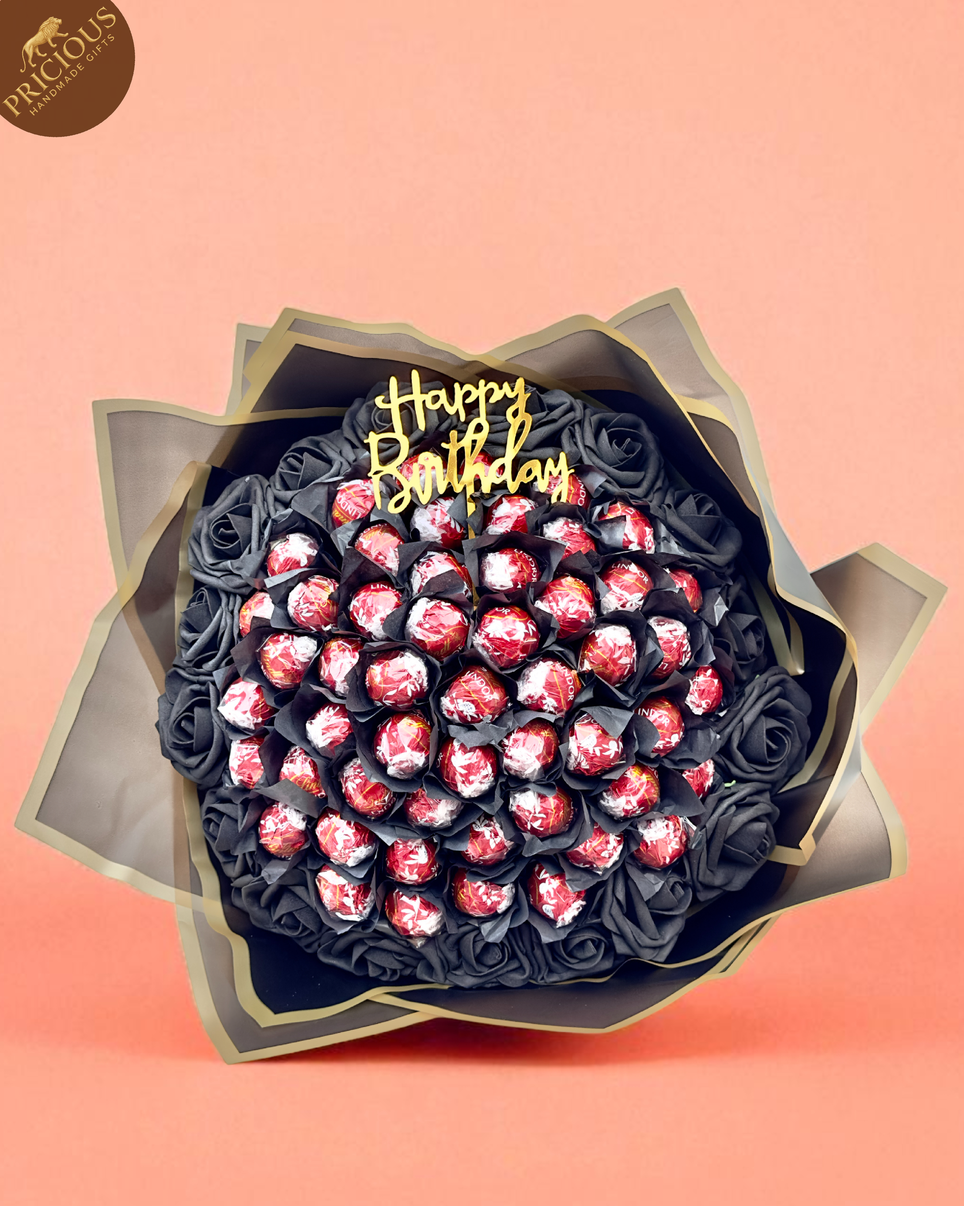 Luxury chocolate gift with “Happy Birthday” topper, satin ribbon and premium wrap.
