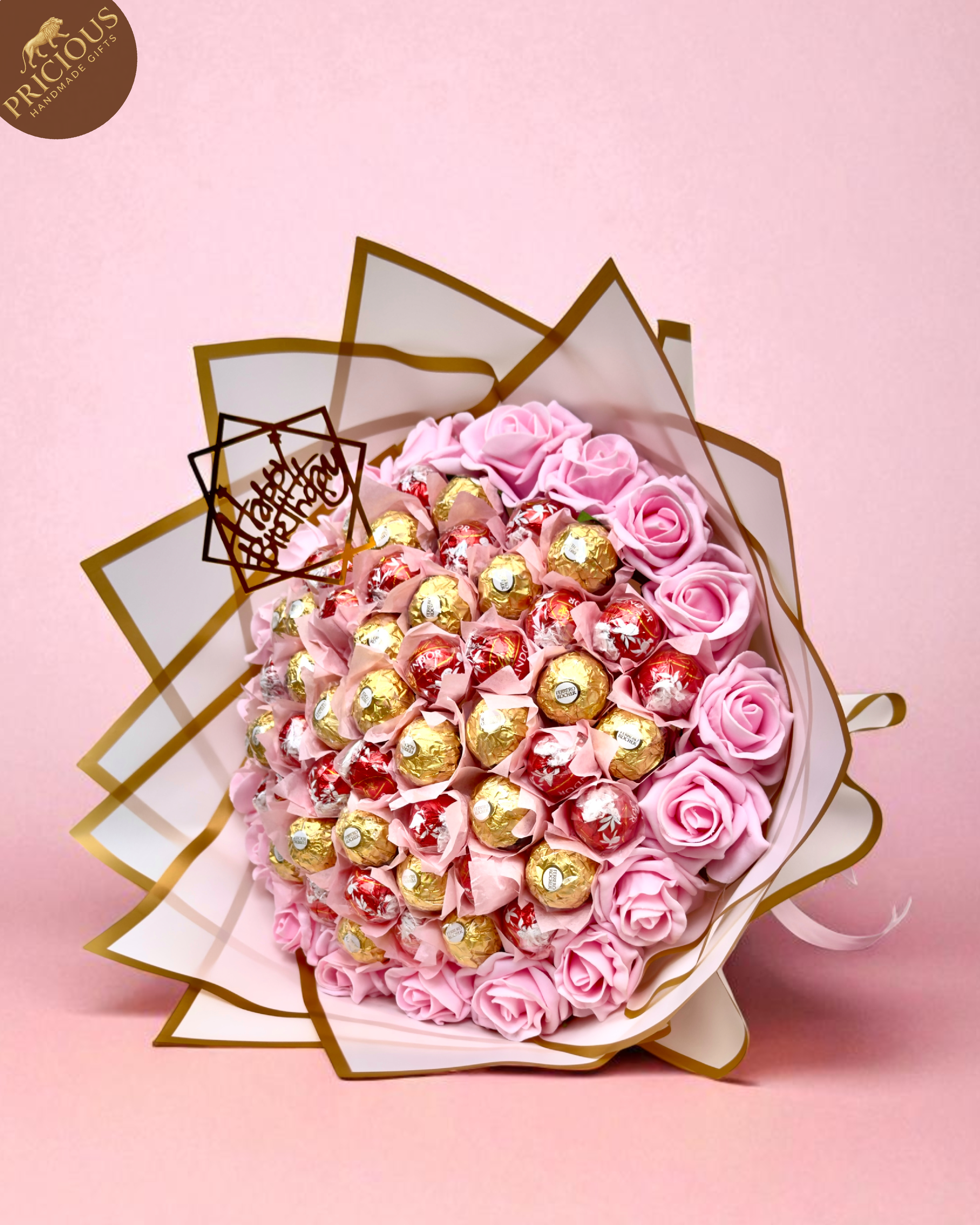 Hand-tied pink birthday chocolate bouquet with Ferrero Rocher, Lindt Lindor and artificial foam roses.