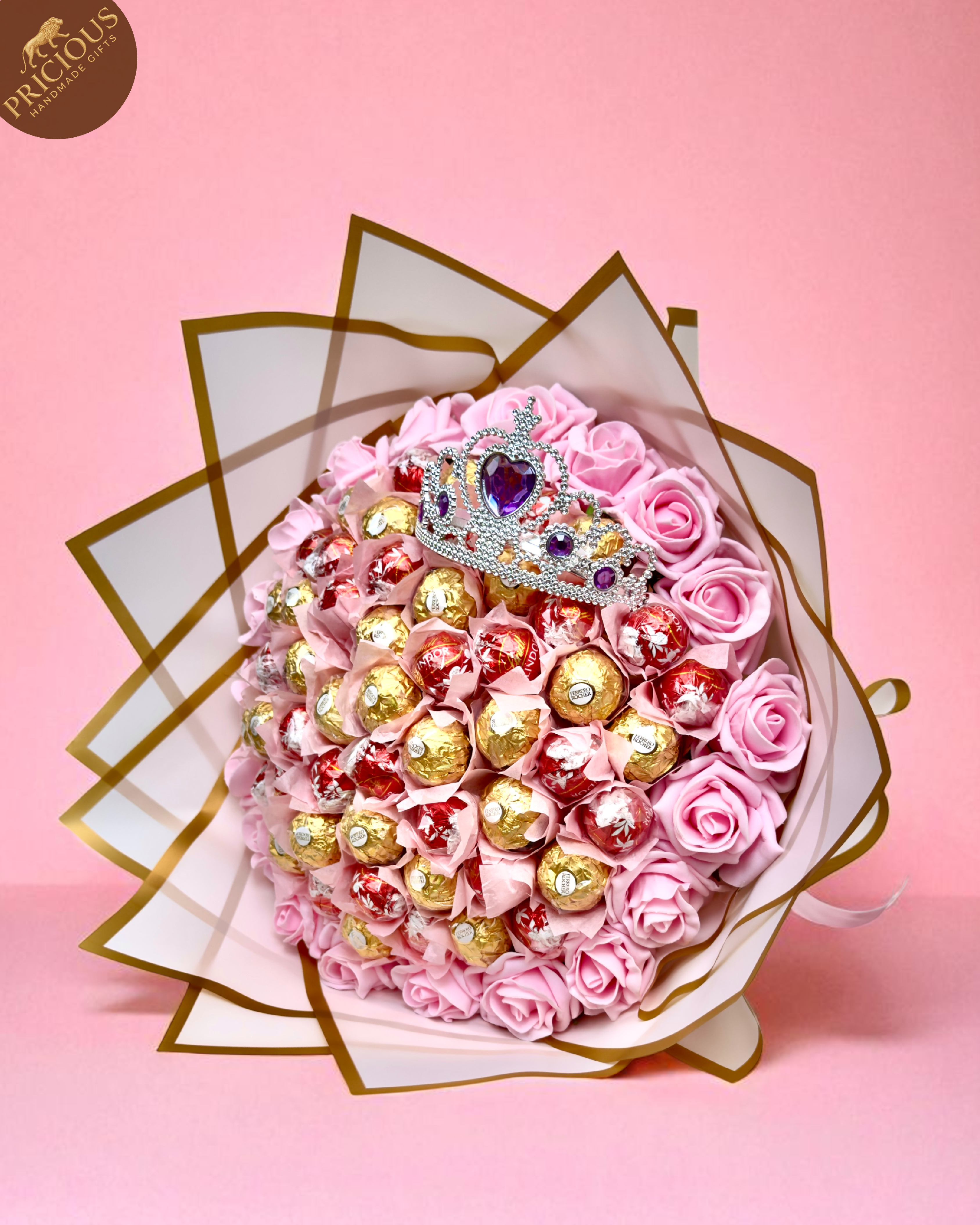 Hand-tied pink tiara chocolate bouquet with Ferrero Rocher, Lindt Lindor and artificial roses.