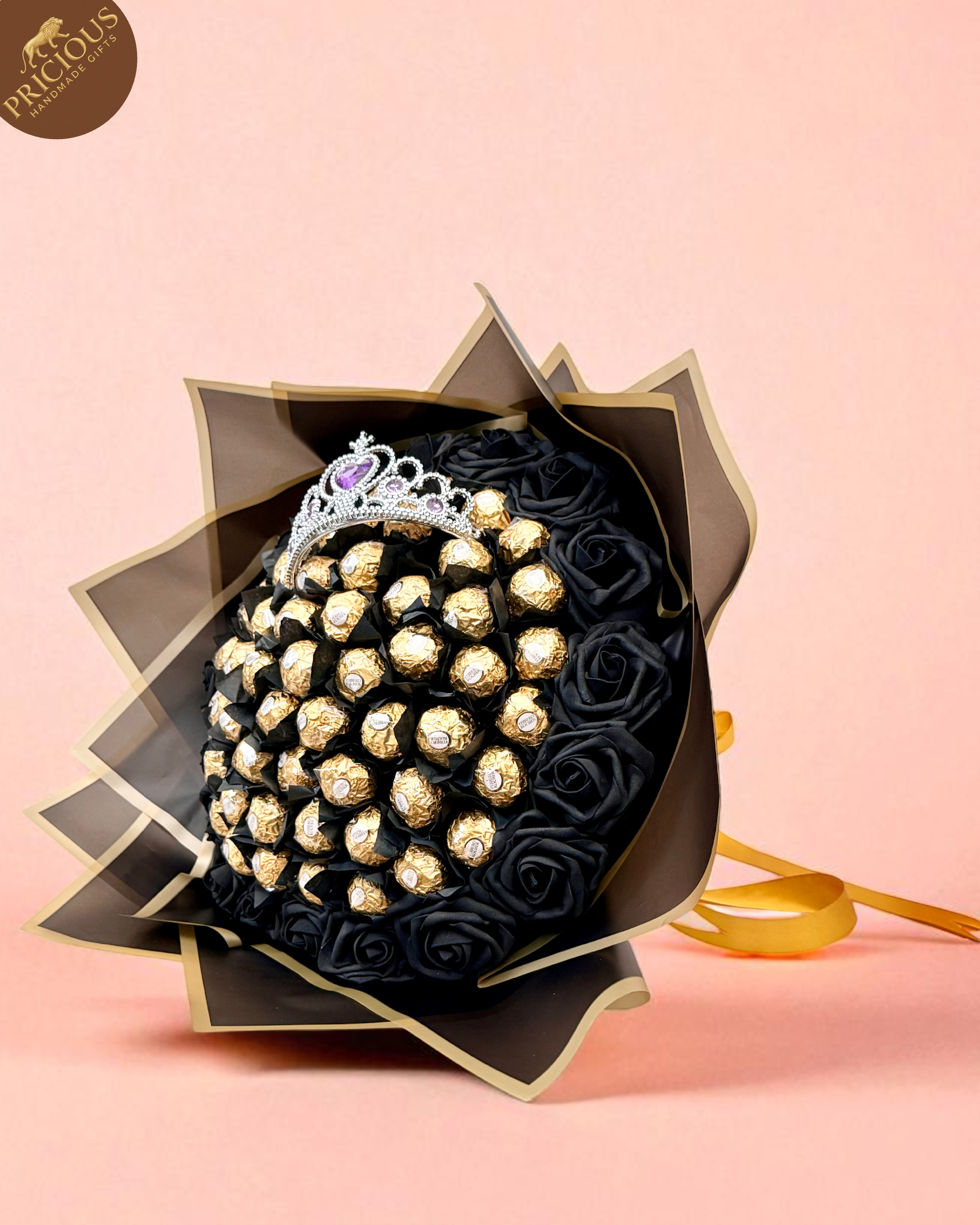 Hand-tied Ferrero Rocher tiara chocolate bouquet in black & gold with artificial foam roses, angled view.