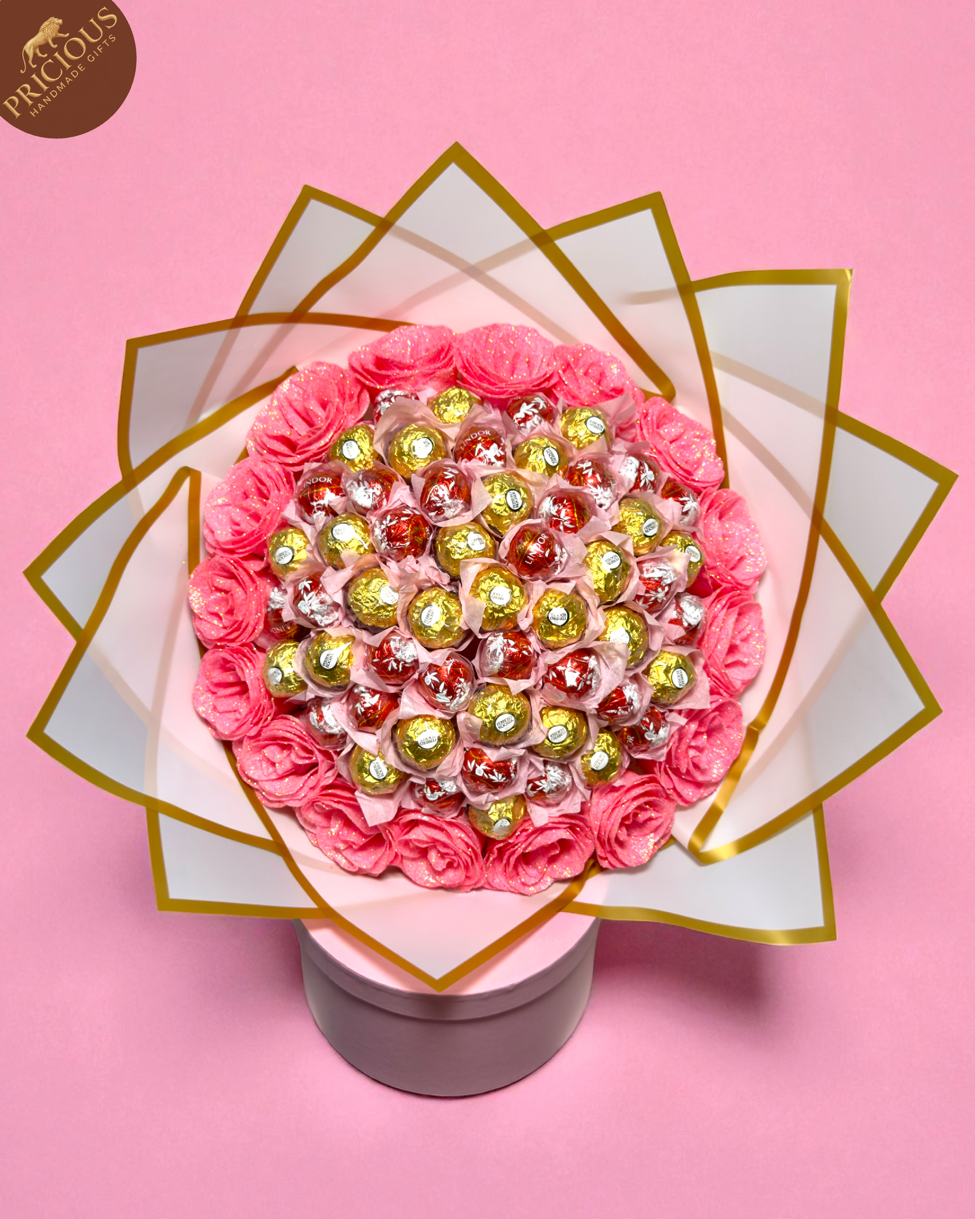 Front-down view of mixed truffles arranged with hand-tied artificial roses.