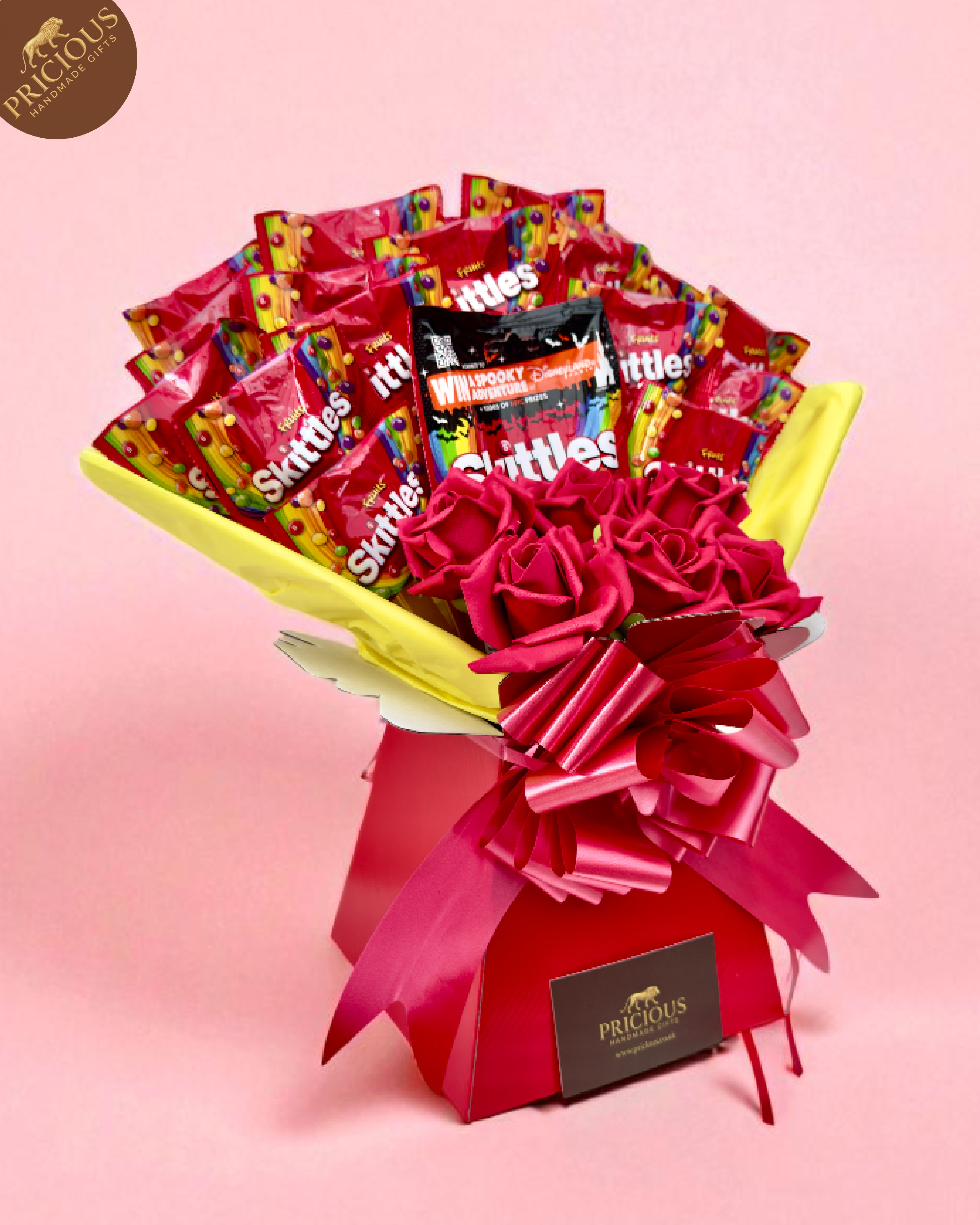 Front view of Skittles bouquet box in hot pink with satin bow and mini packs.
