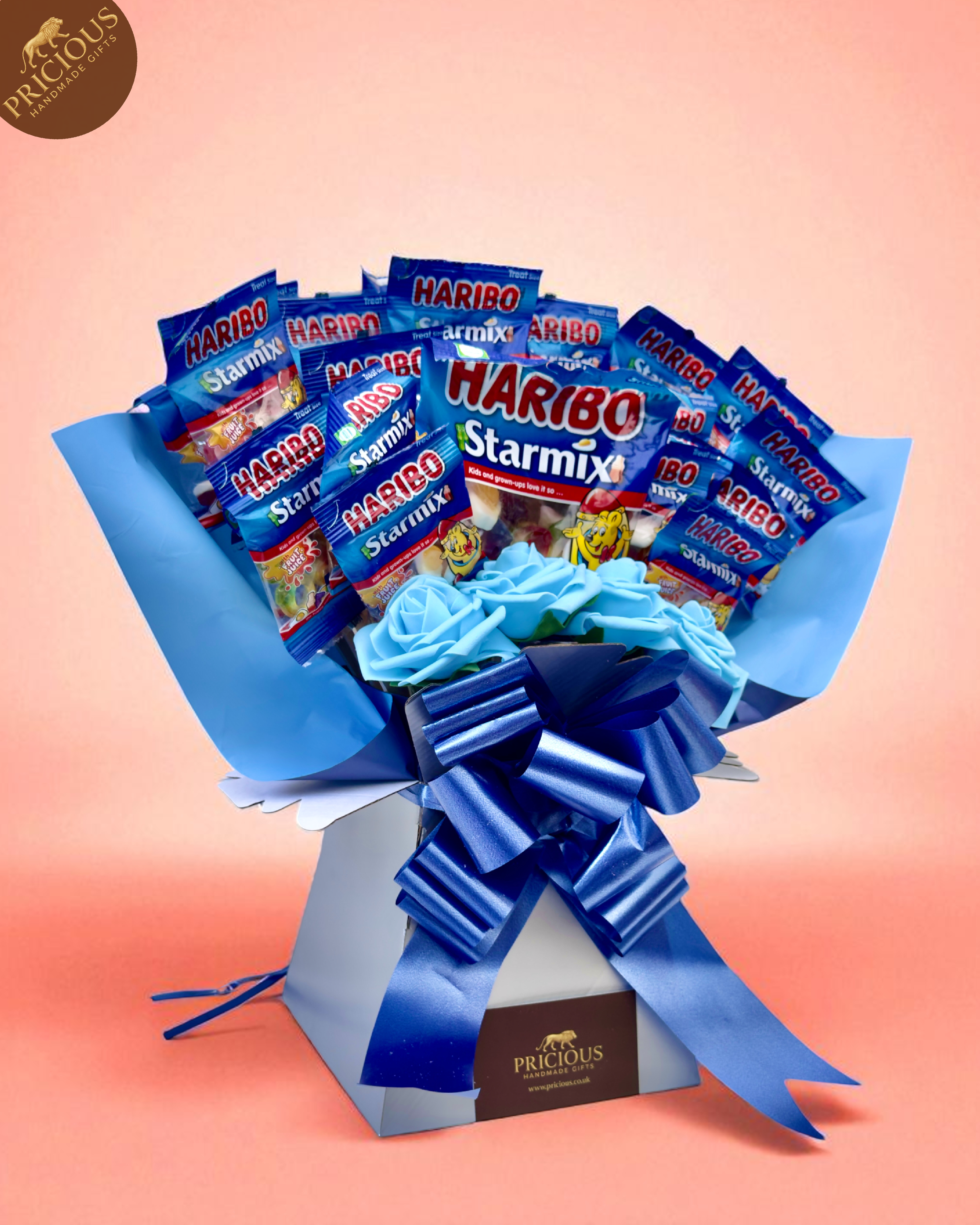 Close-up of Starmix share bag and mini bags arranged among artificial roses.