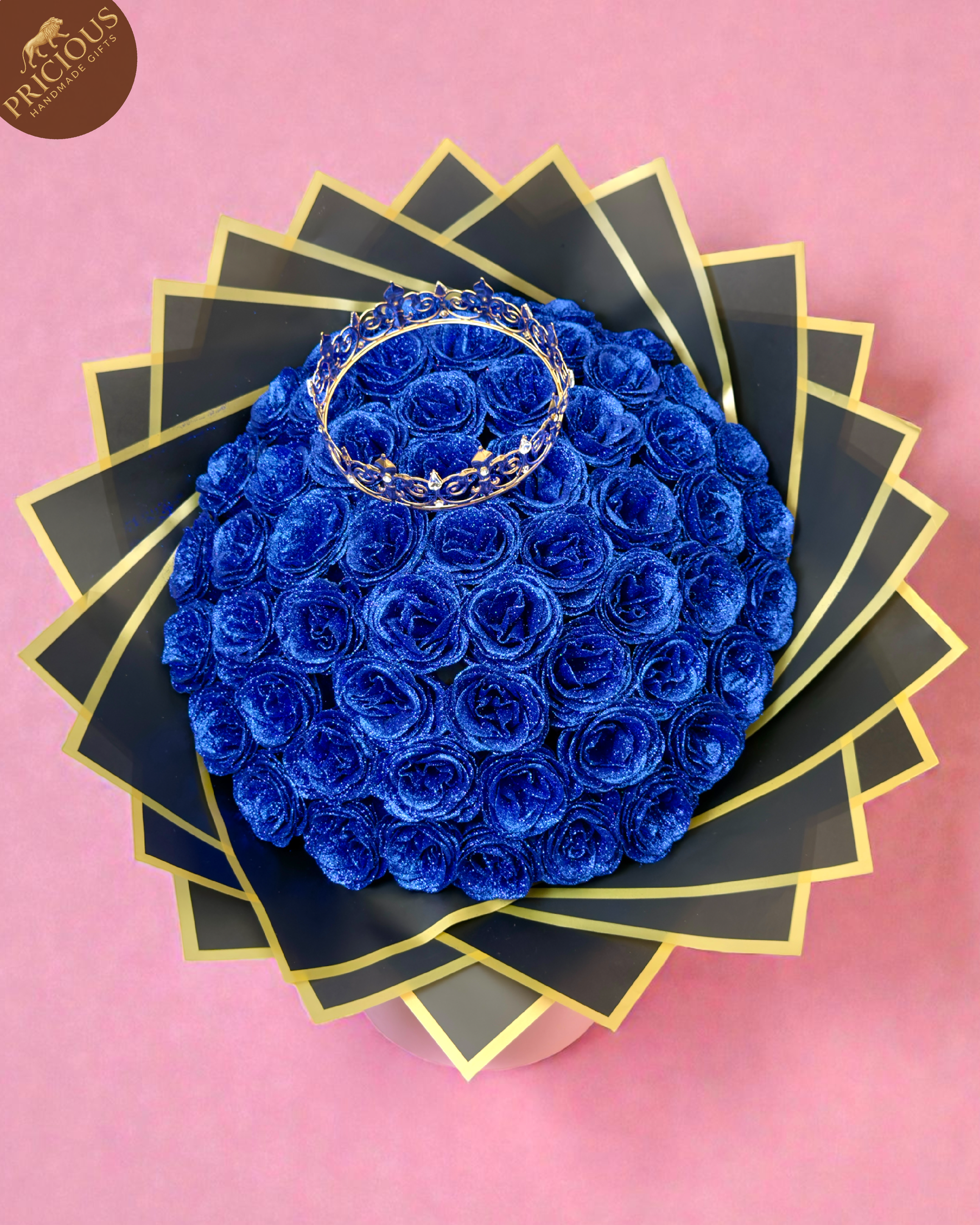 Top view of royal blue glitter roses bouquet with gold king crown topper