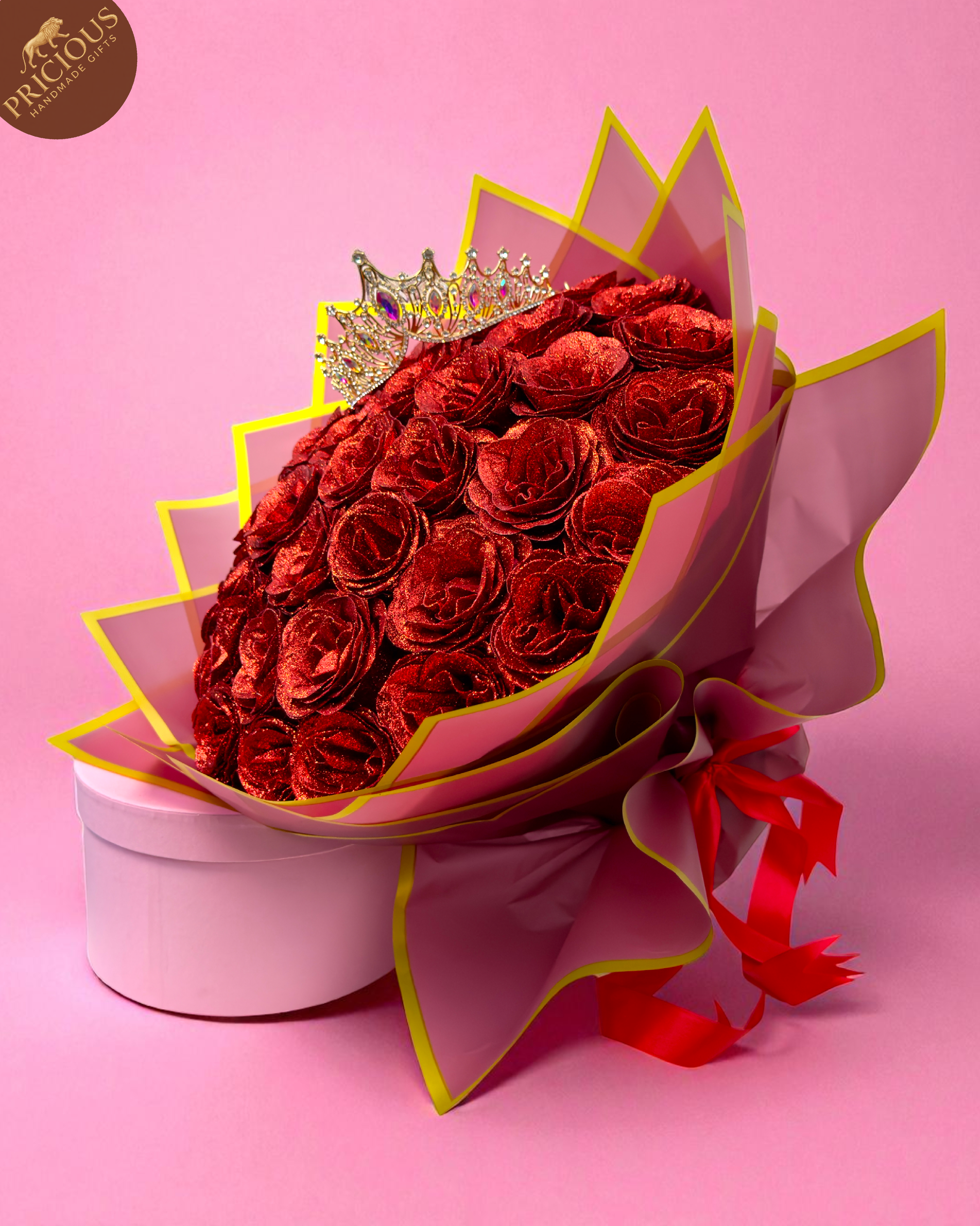 Hand-tied red glitter artificial-rose bouquet with tiara crown, pink & gold wrap (side view).