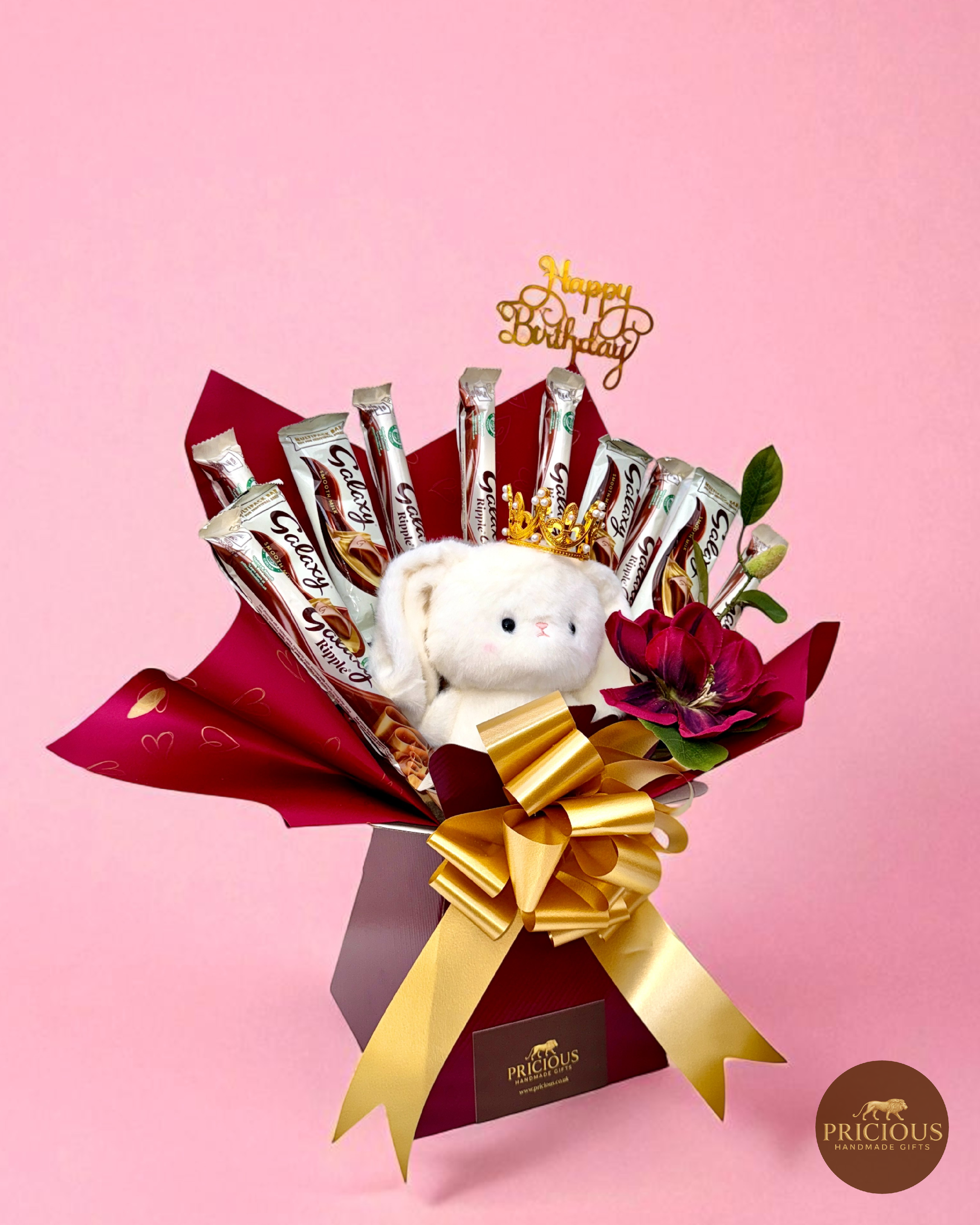 Side view of Galaxy baby girl chocolate bouquet with plush teddy and gold bow