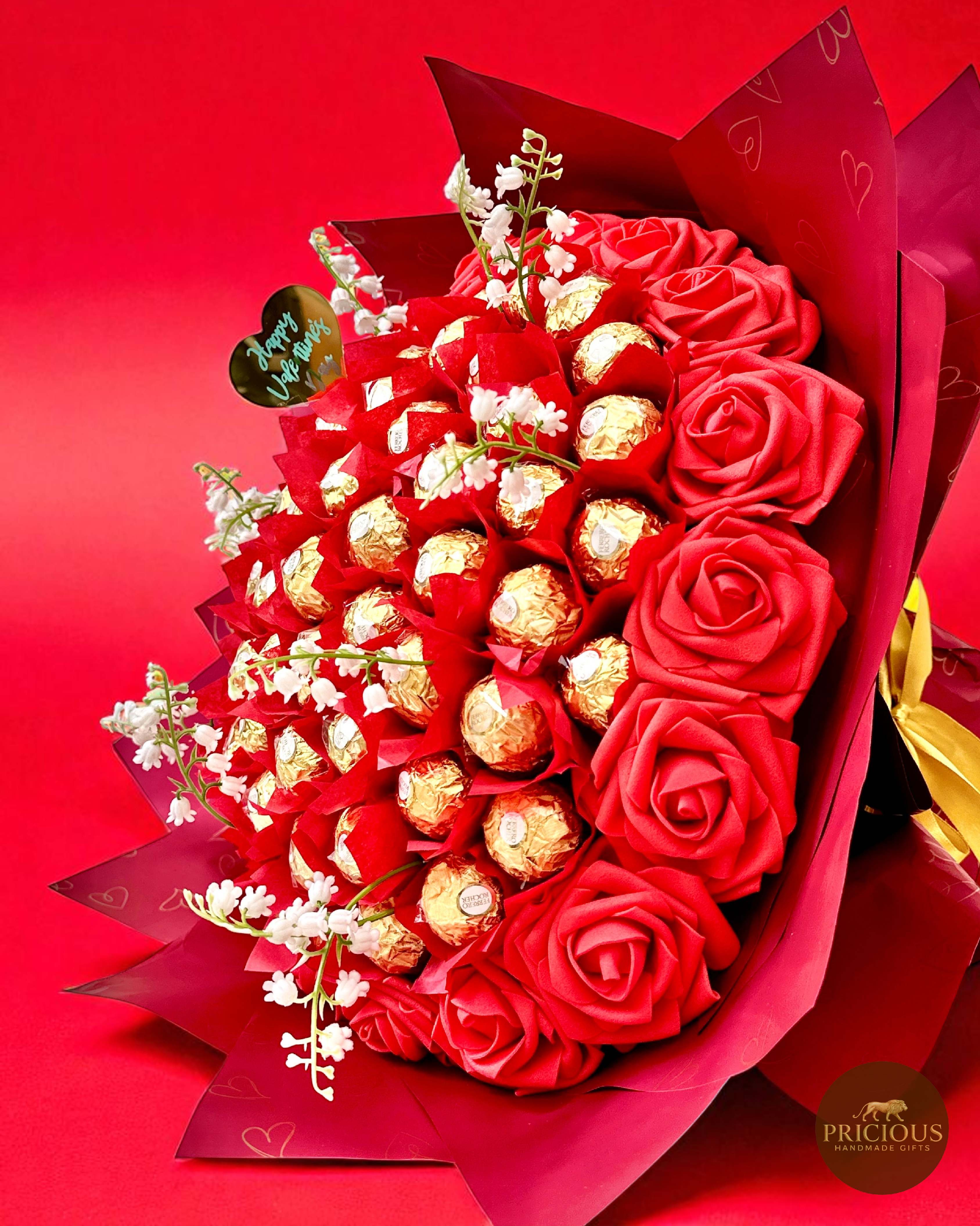 Close front of Ferrero Rocher red rose bouquet (gold accents)