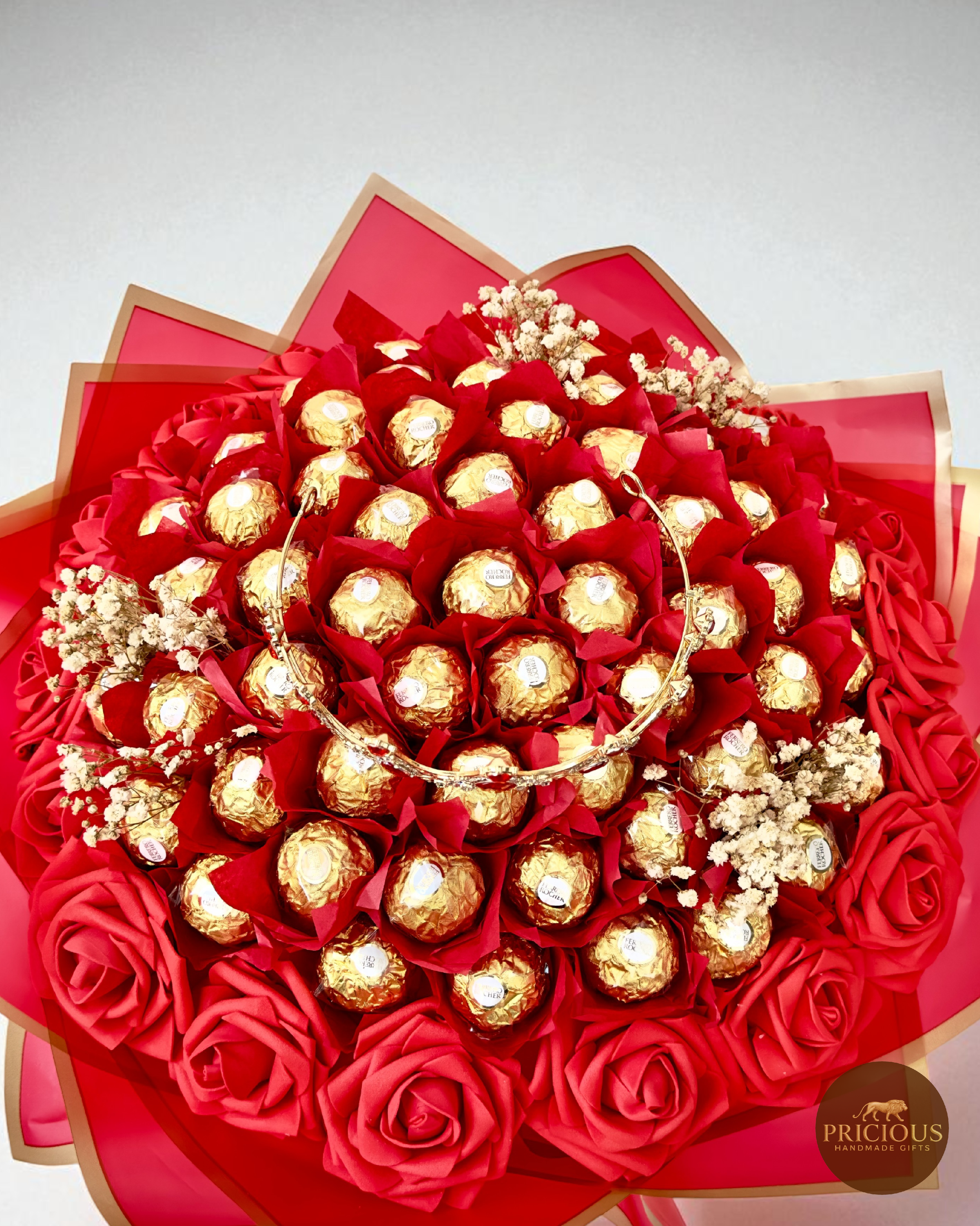 Side view of Ferrero Rocher crown bouquet with red wrap and gold edging