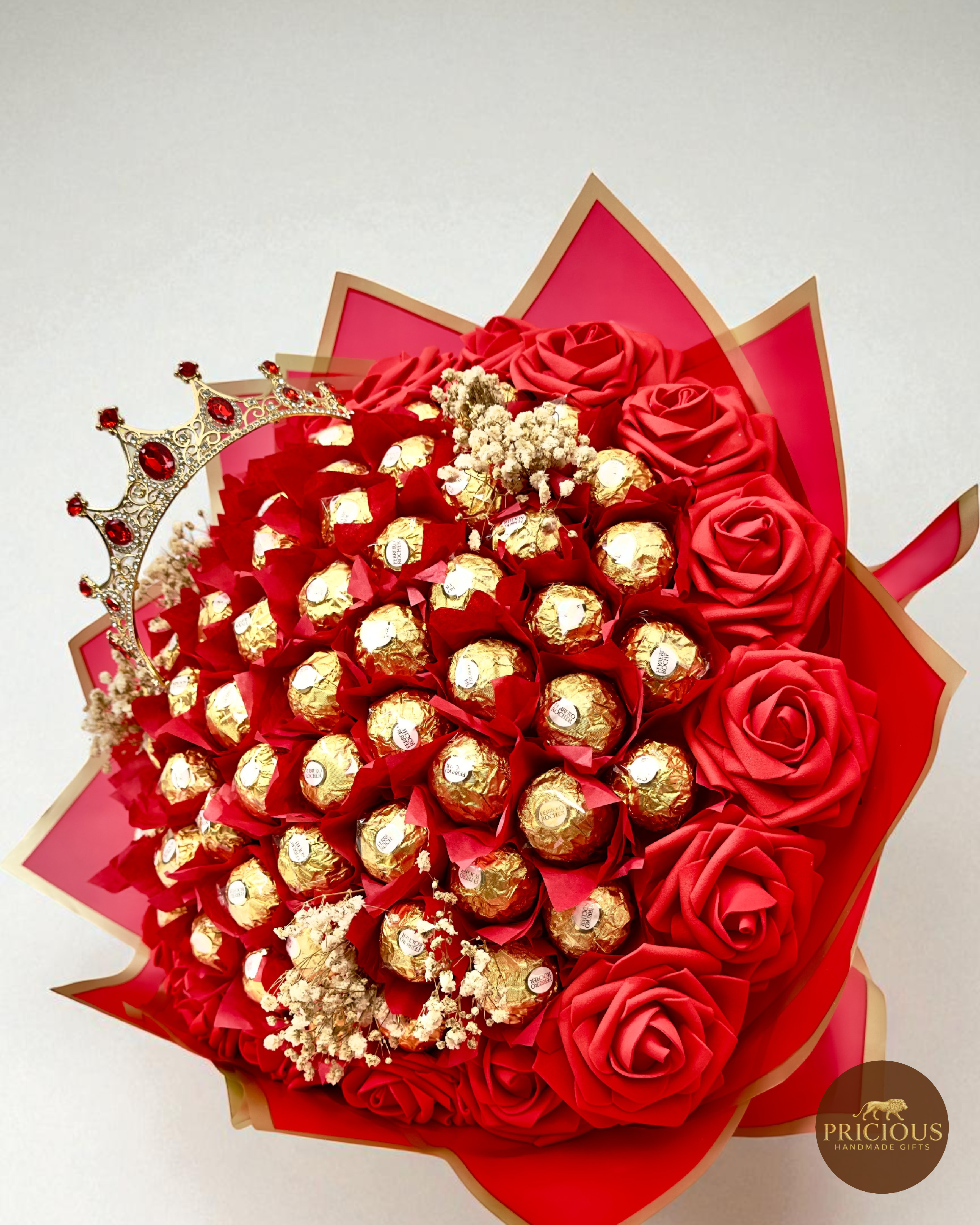 Side view of crown Ferrero Rocher bouquet with red wrap and gold edging