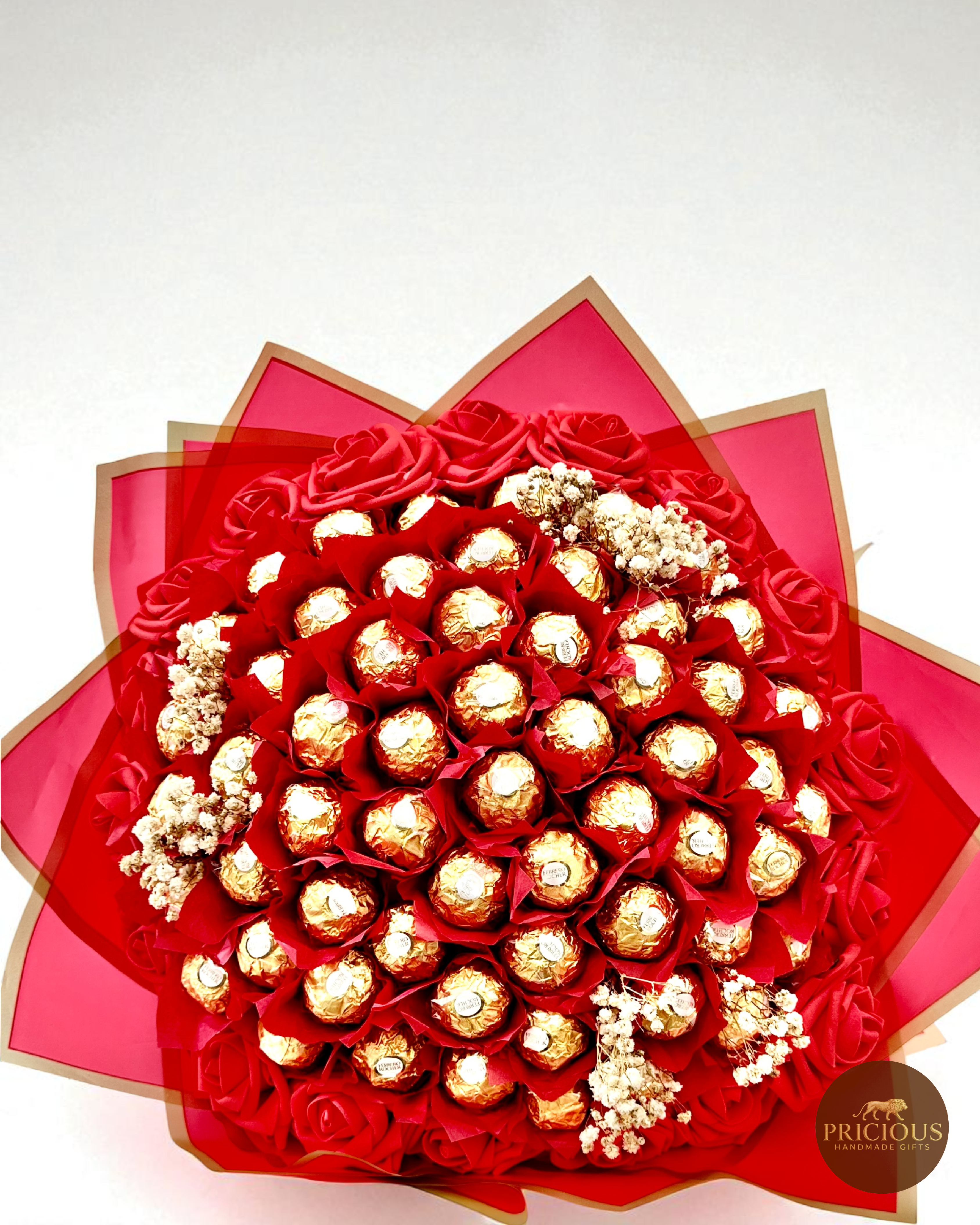 Bouquet of gold Ferrero Rocher chocolates and red roses in a decorative box with 'Precious' branding.