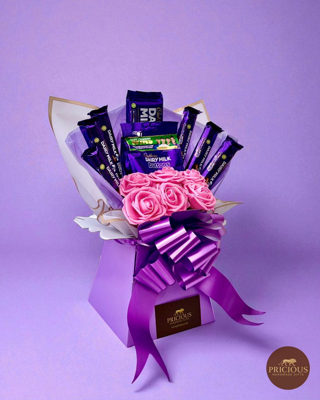 Side view Cadbury Dairy Milk bouquet with pink roses and Buttons share bag