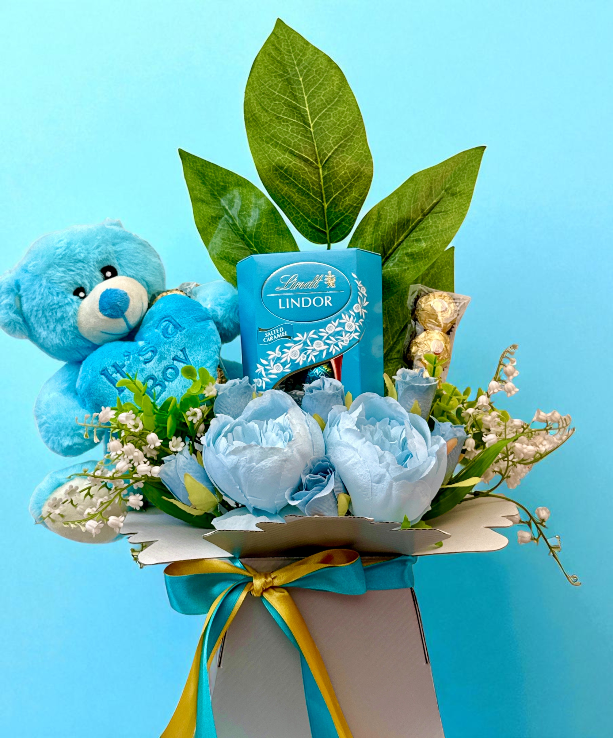 Close-up Lindt Lindor Baby Boy bouquet with teddy and blue florals