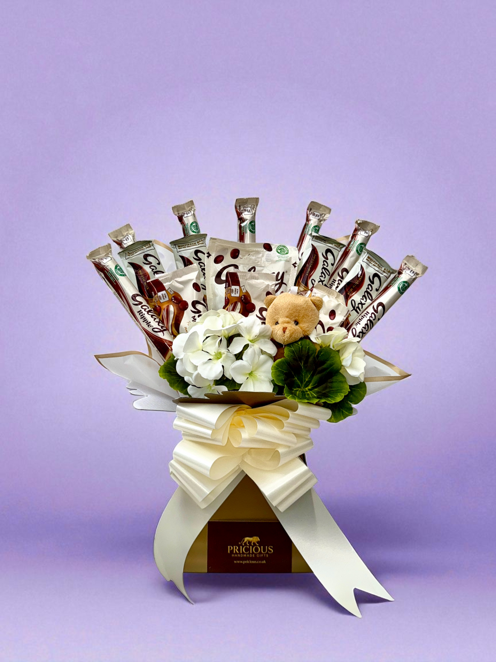 Front view Galaxy ivory chocolate bouquet with large ivory bow